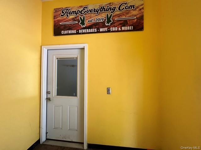 Doorway to outside featuring baseboards