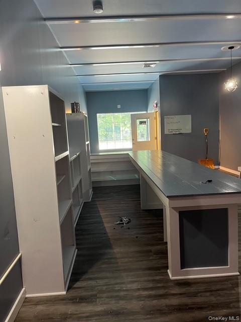 Unfurnished office featuring dark wood finished floors