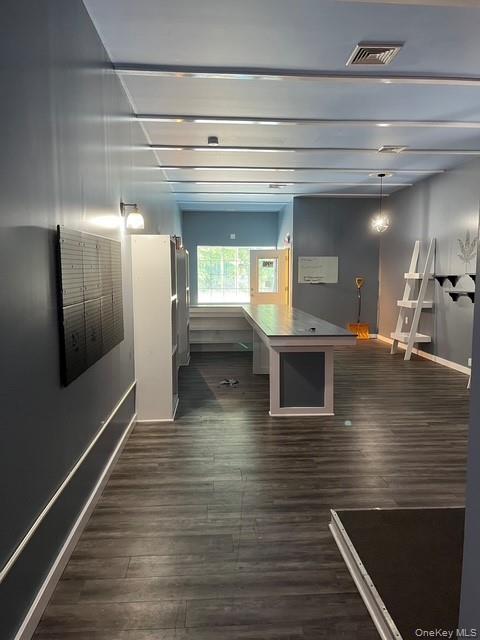 Game room with dark wood-type flooring and baseboards