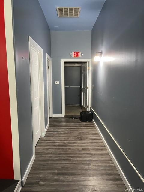 Corridor with dark wood-style flooring
