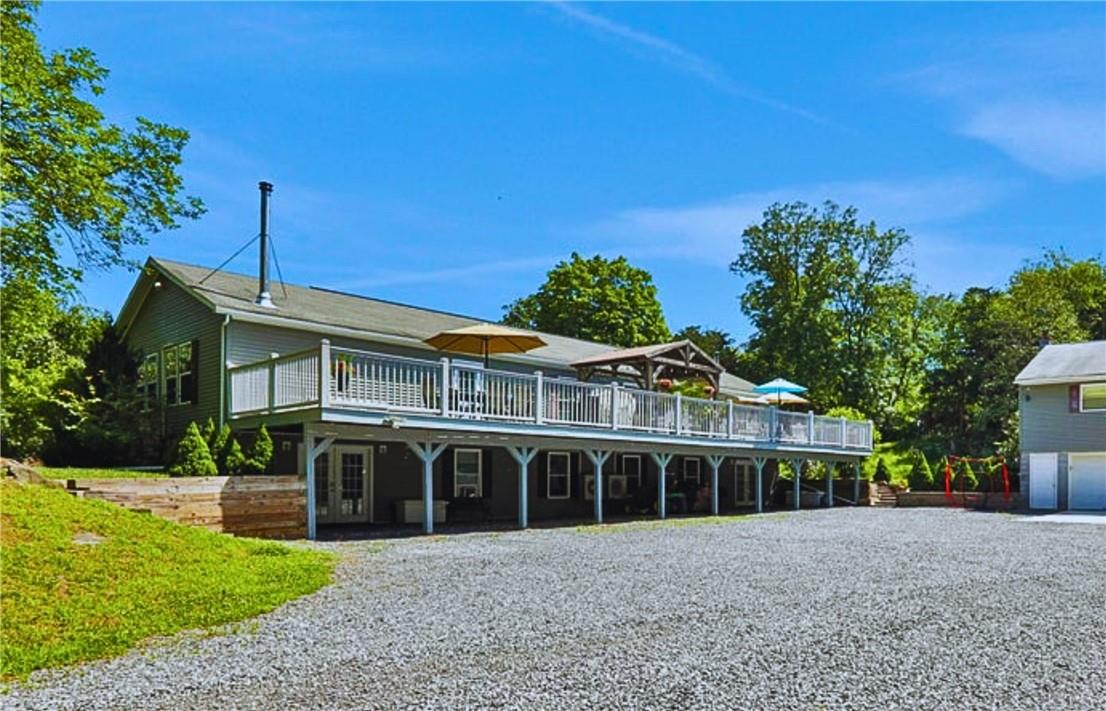 View of front of home with a wooden deck