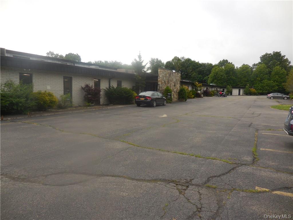 Front of the property with part of the parking area.