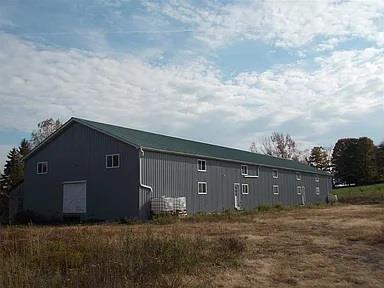 View of side of home featuring an outdoor structure