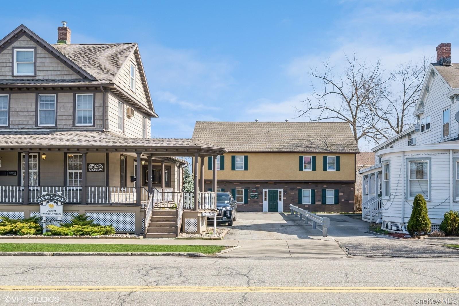View of front of  showing building in front and 12 St John St.