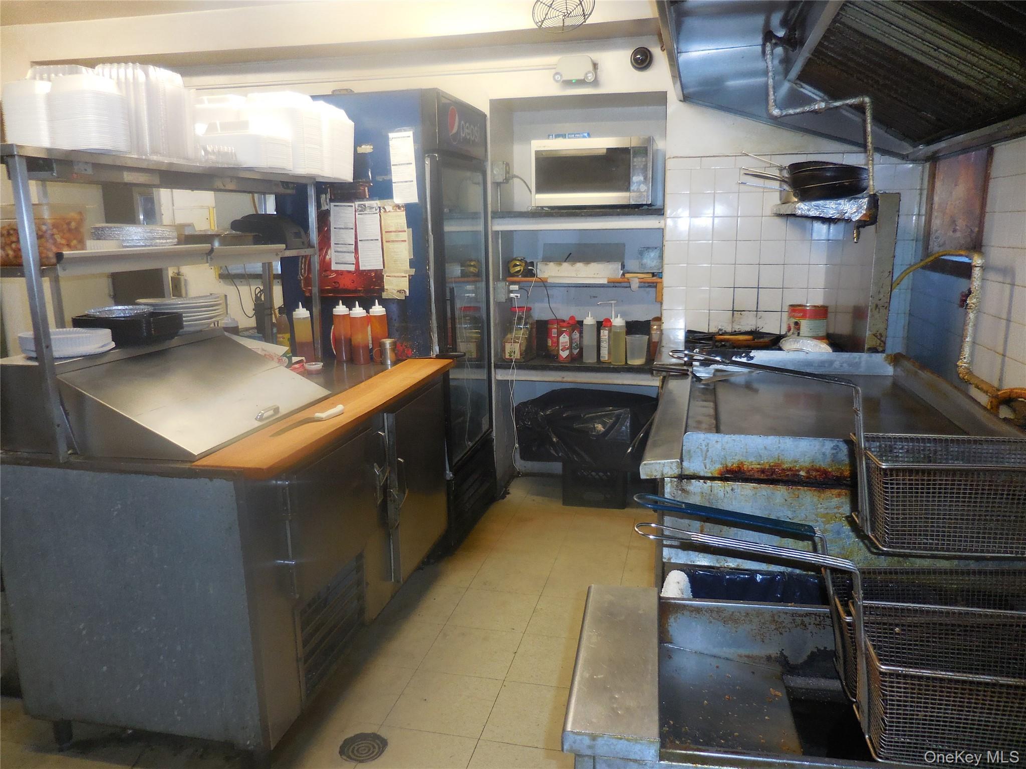 Kitchen hood, grill, fryer and ben mari station...