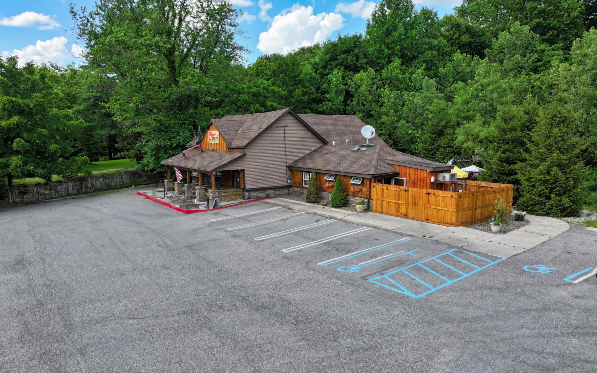 Uncovered parking lot with a wooded view