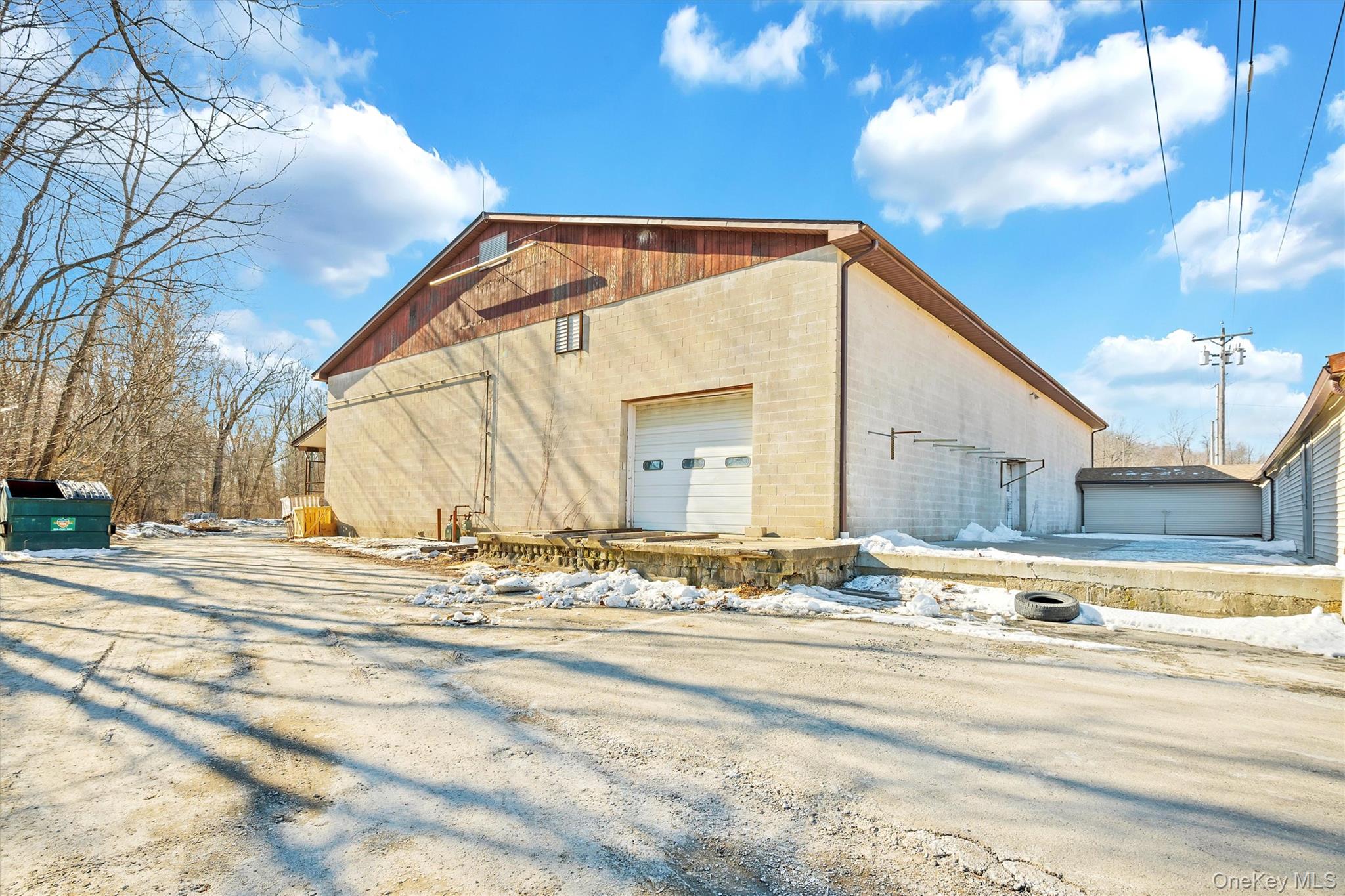 Snow covered property with a garage