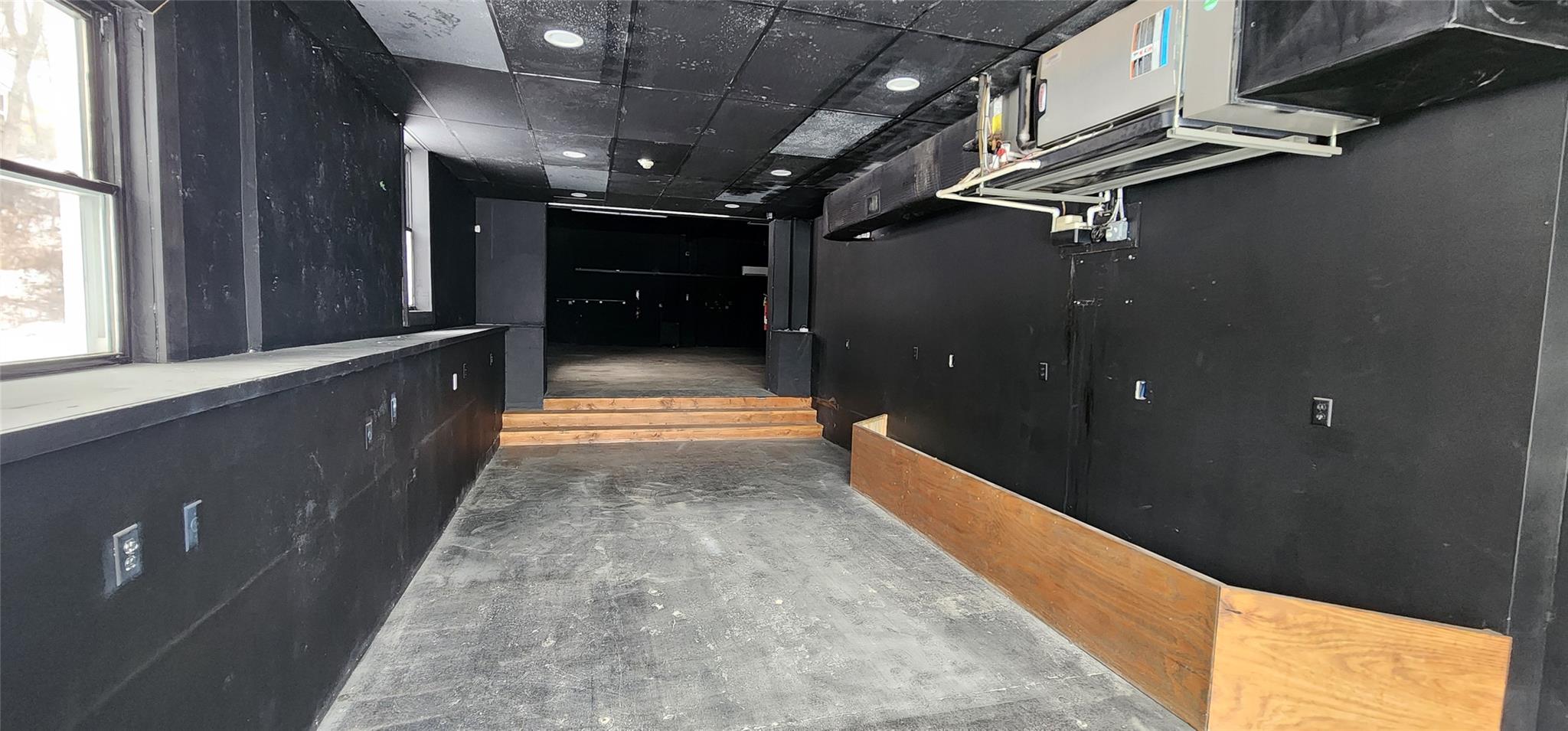 Corridor featuring a paneled ceiling