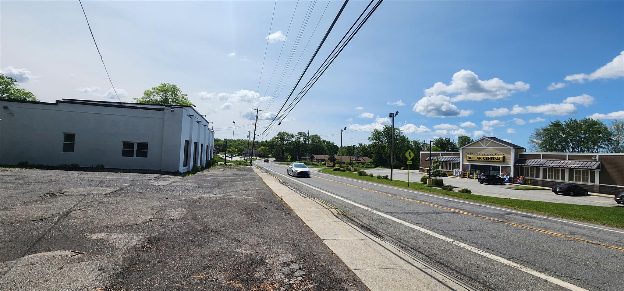 View of asphalt road with street lighting