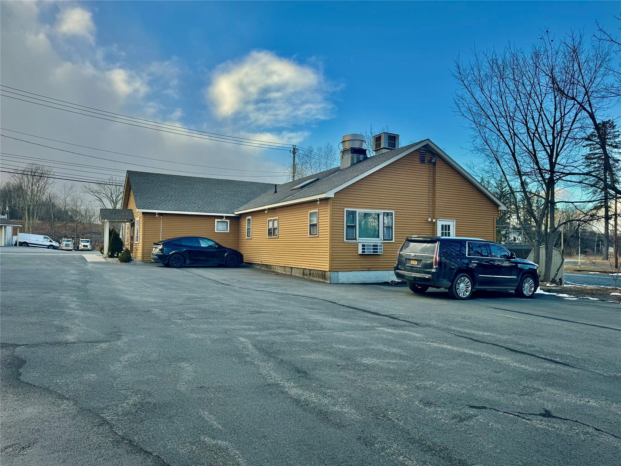 View of side of home with central AC