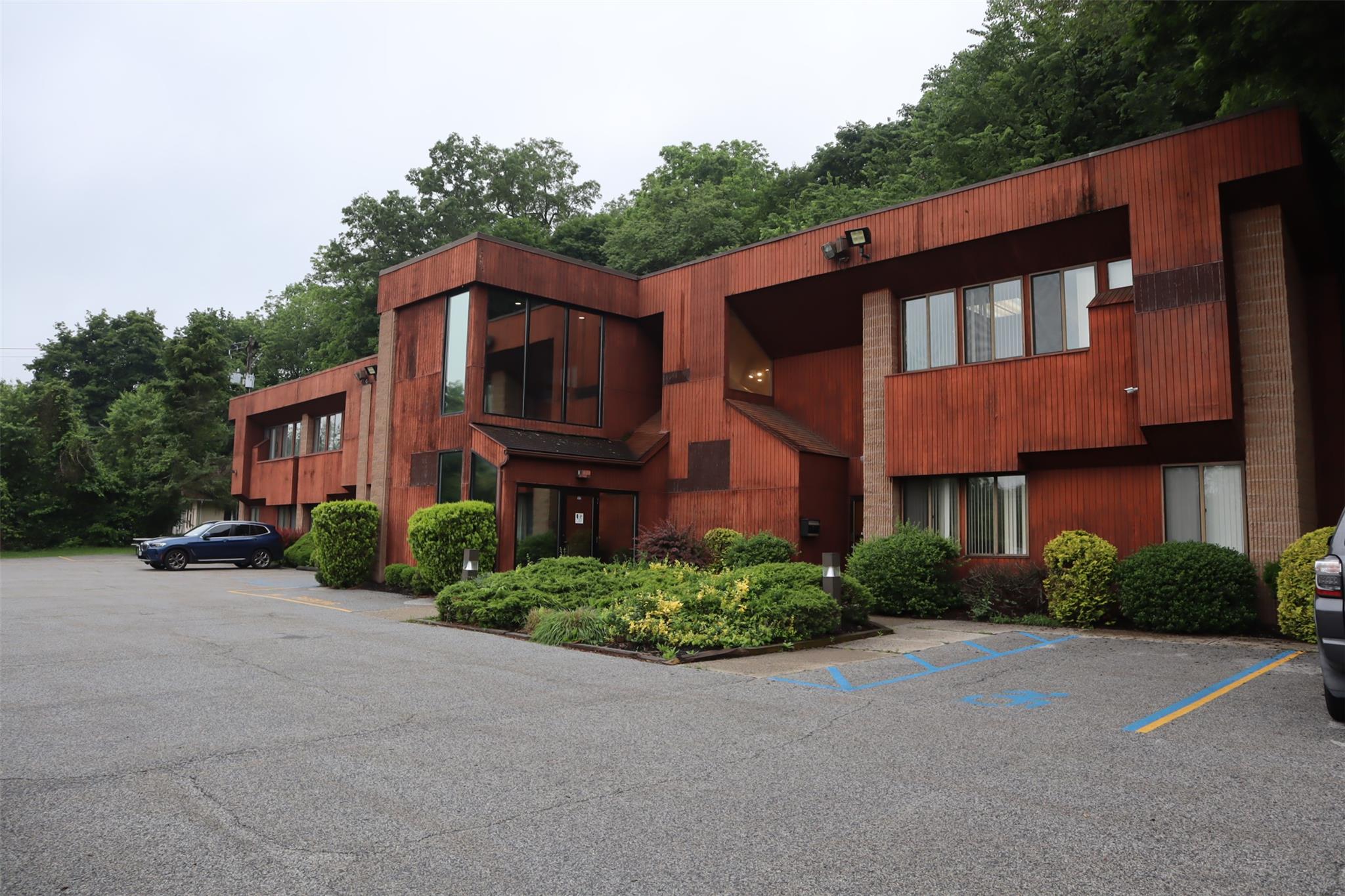 View of building exterior with uncovered parking