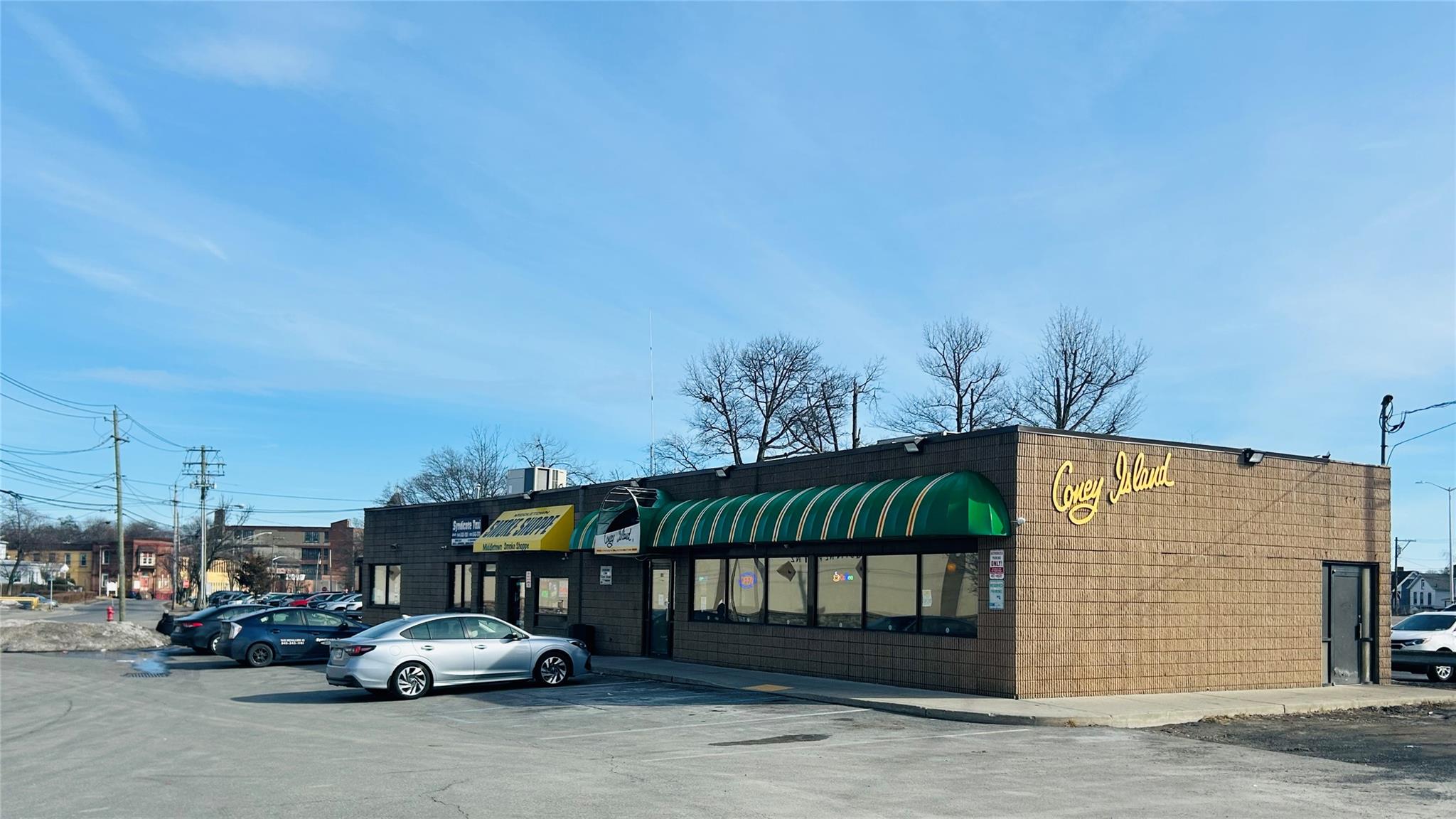 View of building exterior featuring uncovered parking