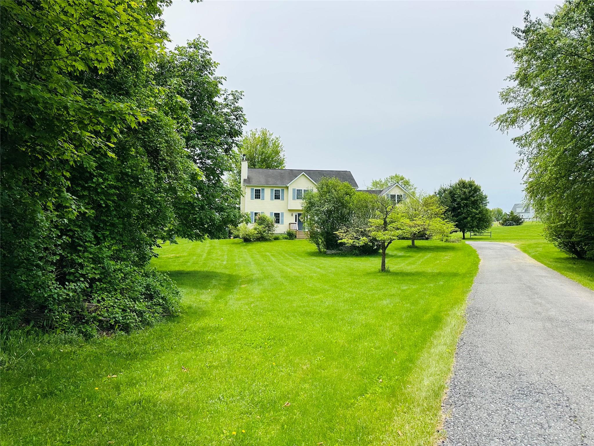 View of front of house featuring a front yard and a chimney