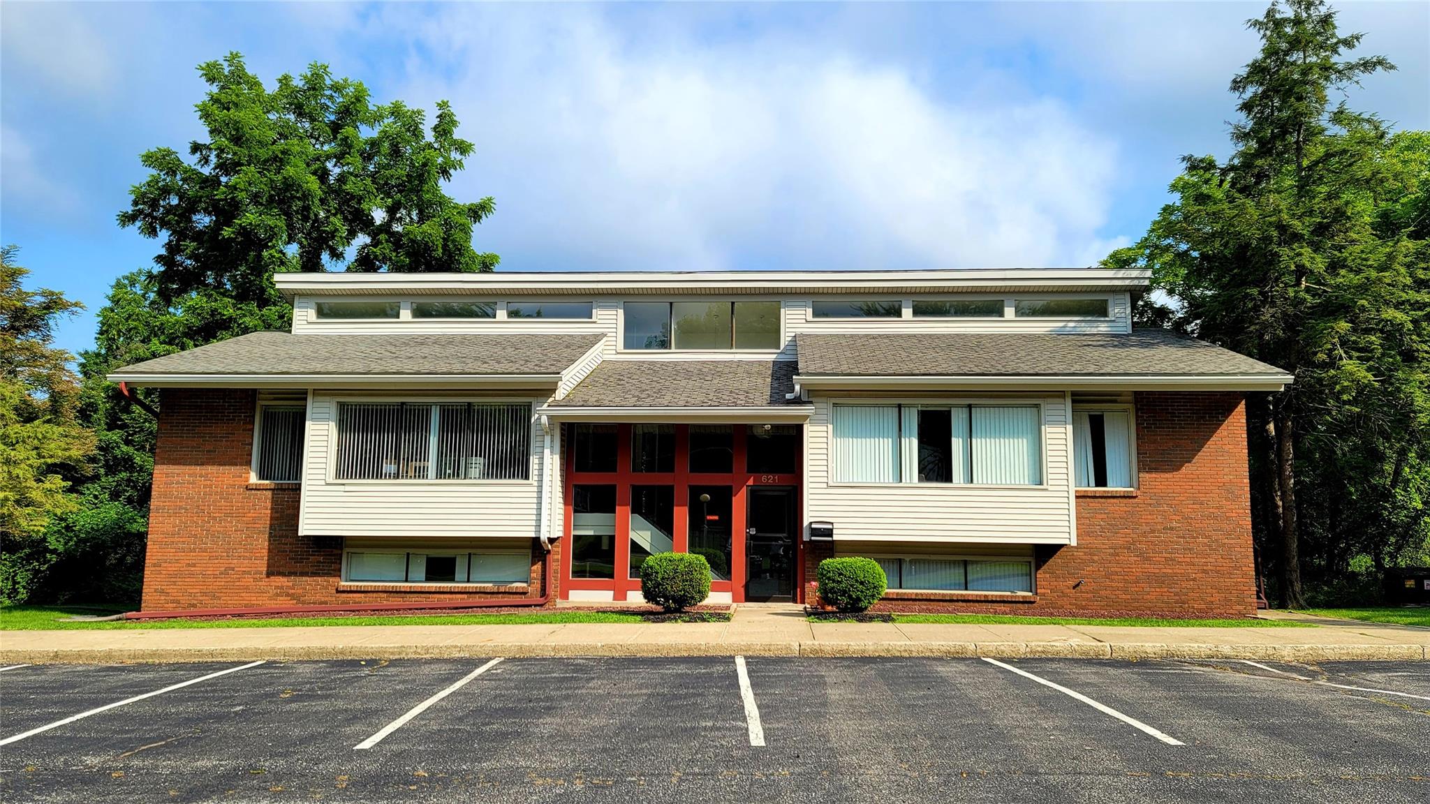 View of property featuring uncovered parking