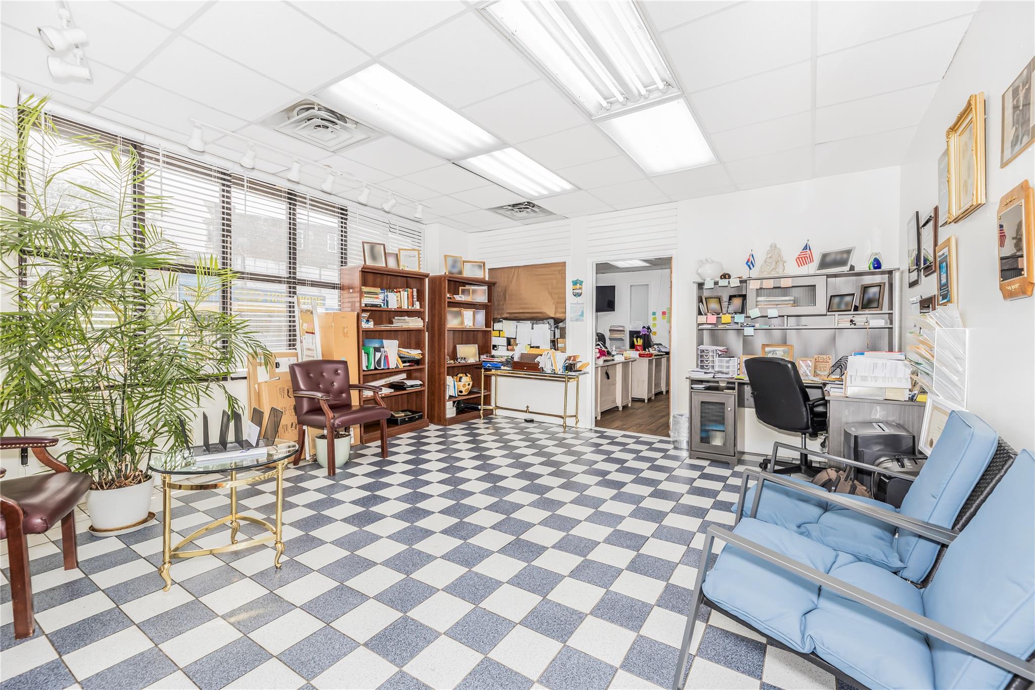 Office area featuring tile patterned floors and a paneled ceiling