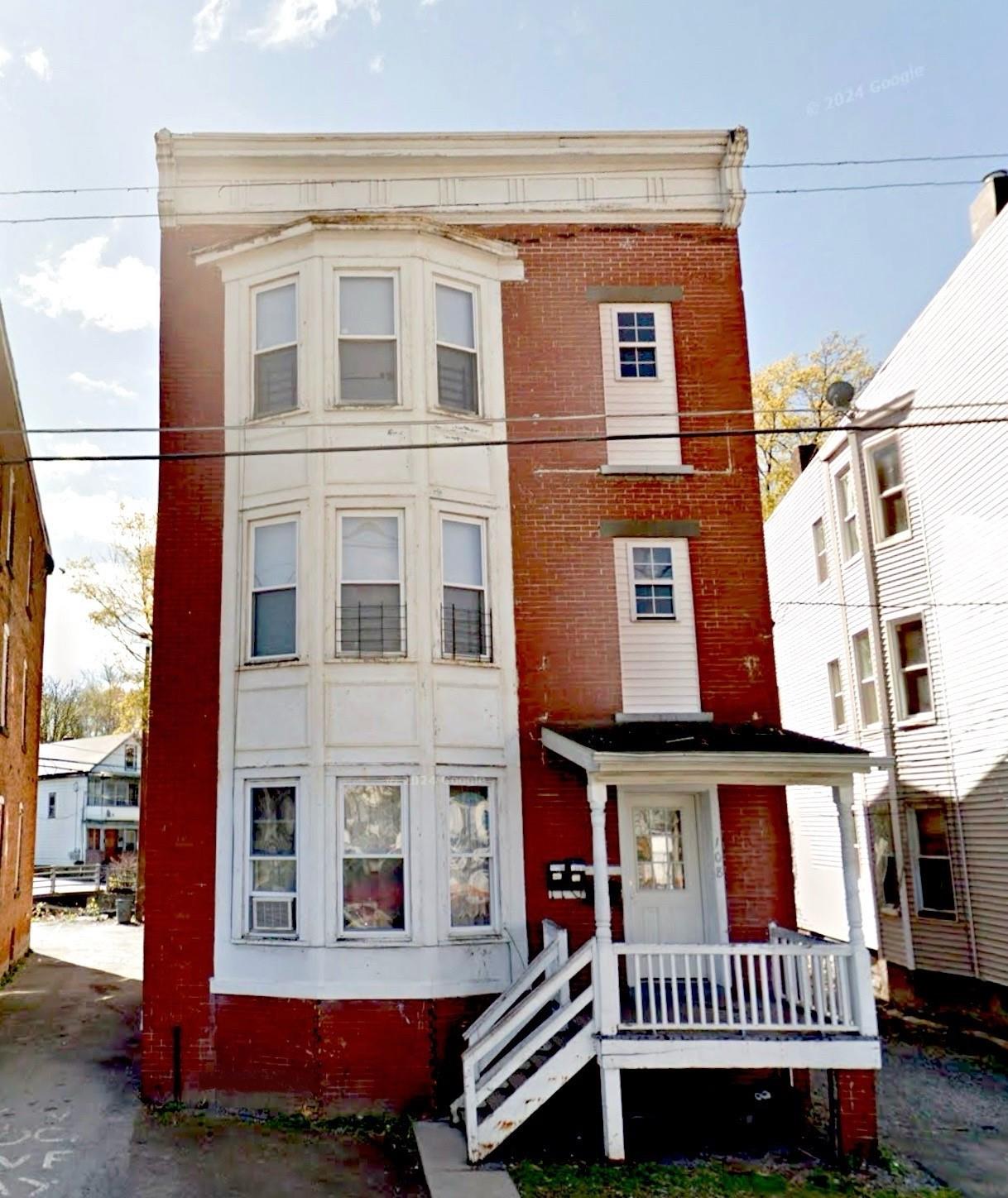 View of front facade featuring brick siding