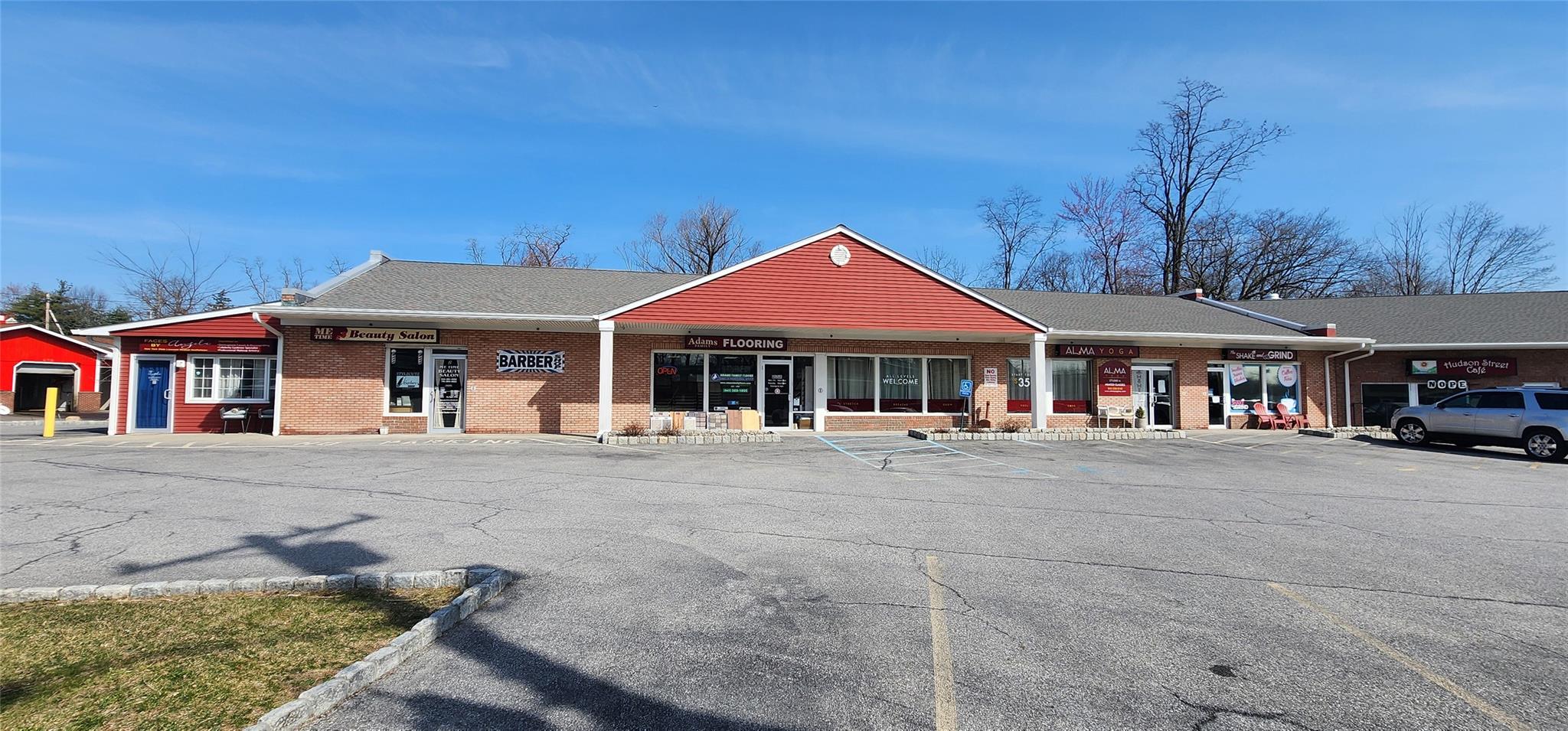 View of property featuring uncovered parking