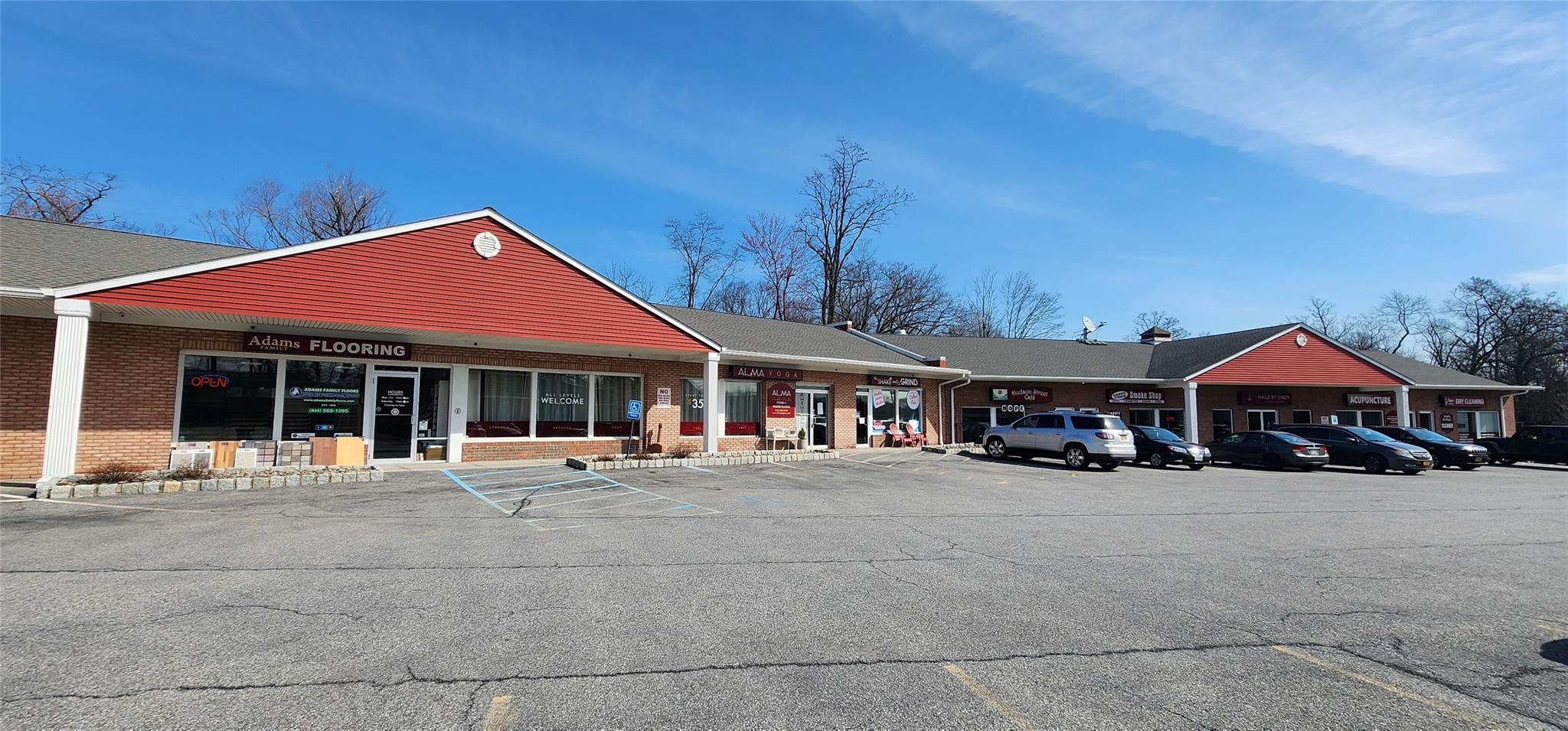 View of property featuring uncovered parking