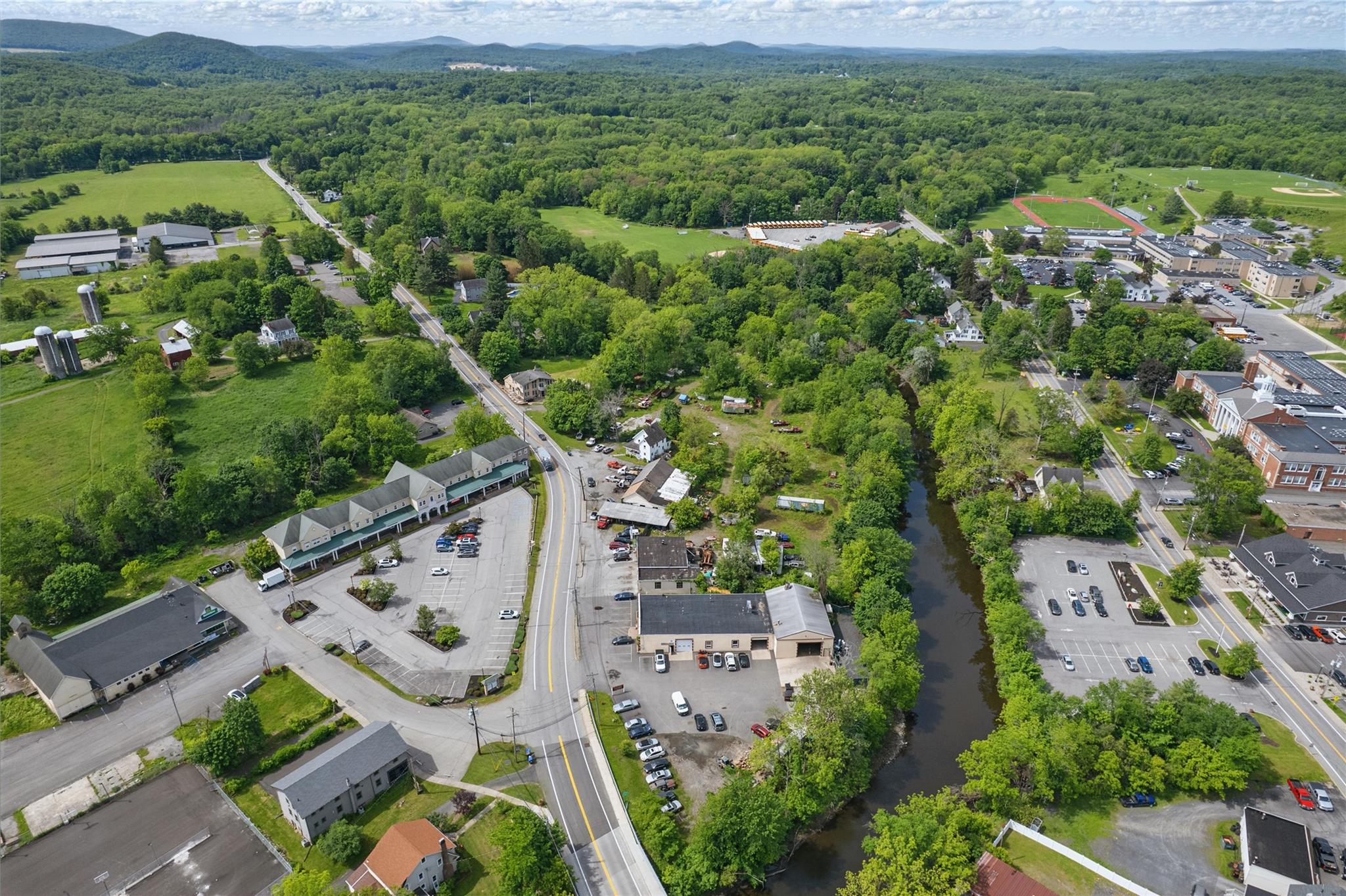 Aerial view of property's location with a heavily wooded area