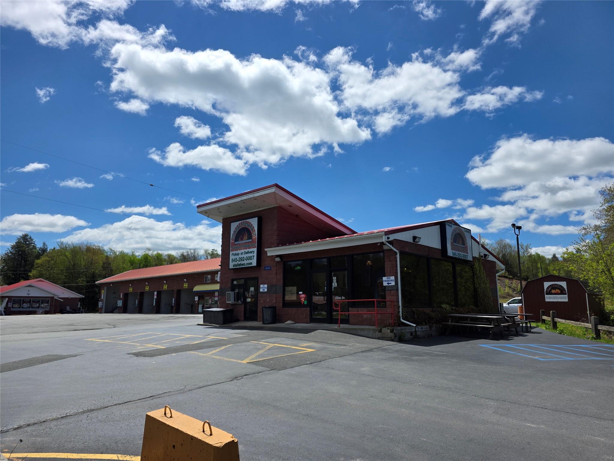 View of commercial location with uncovered parking