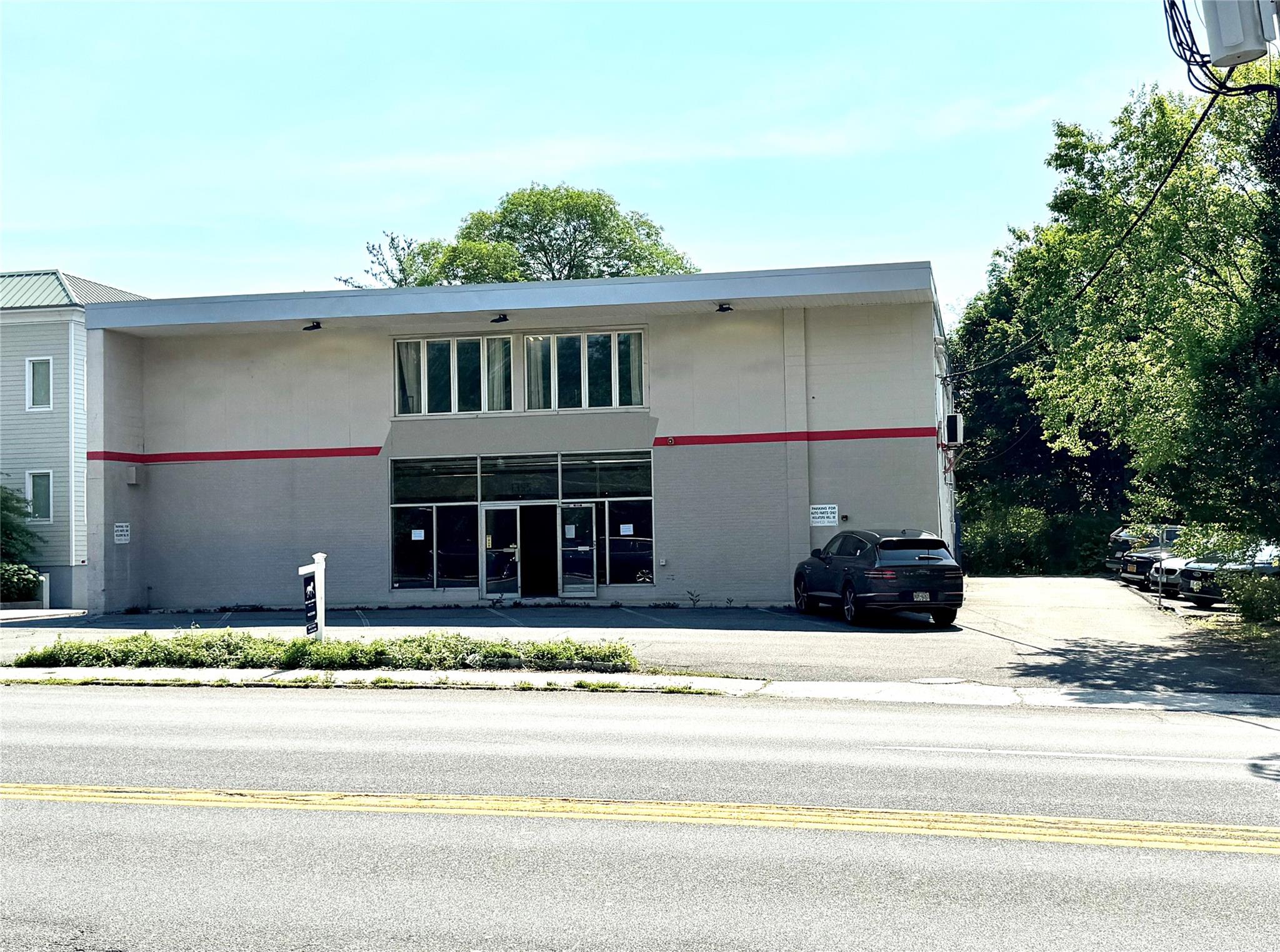 View of building exterior with parking