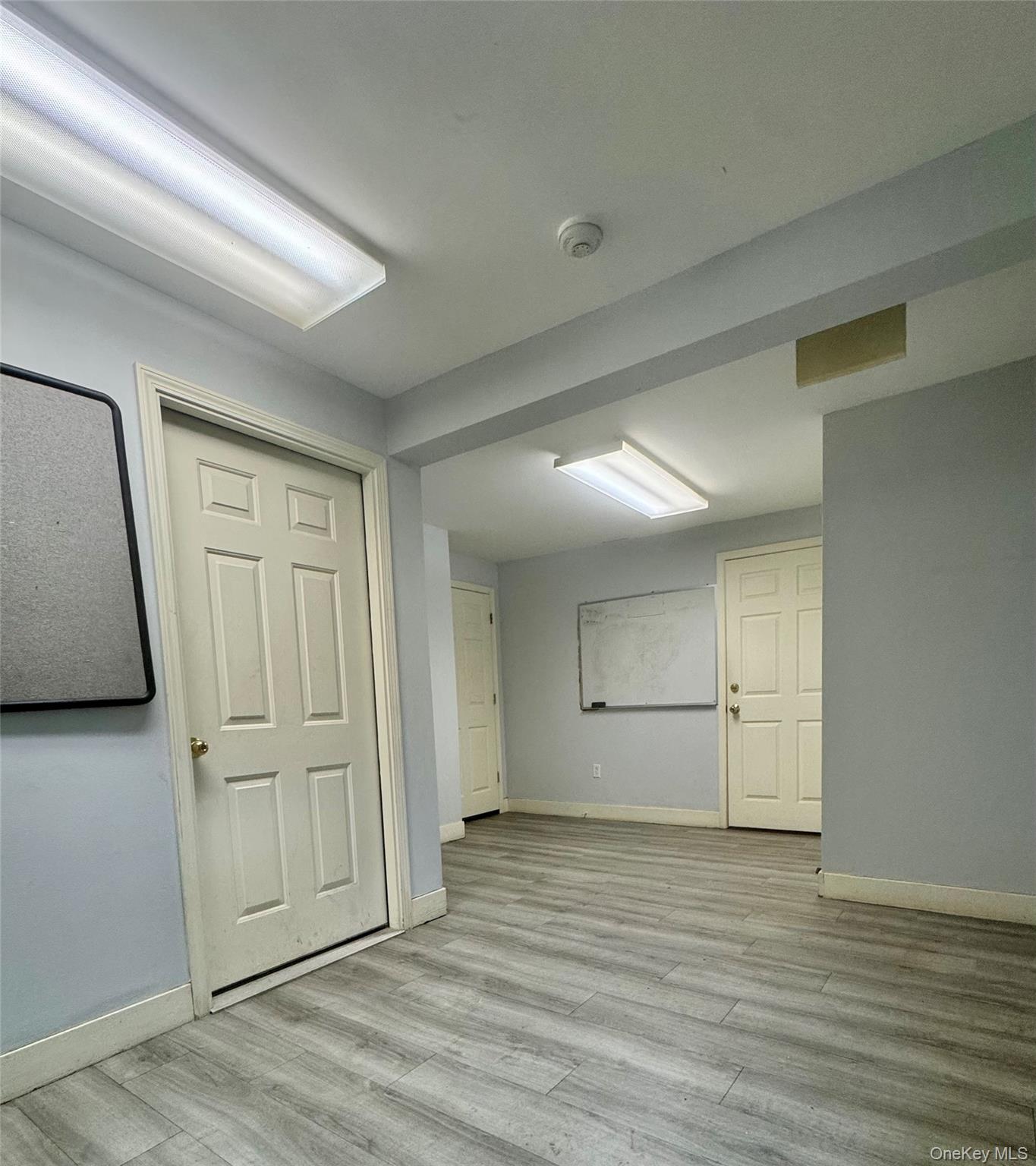 Basement featuring light wood finished floors and baseboards