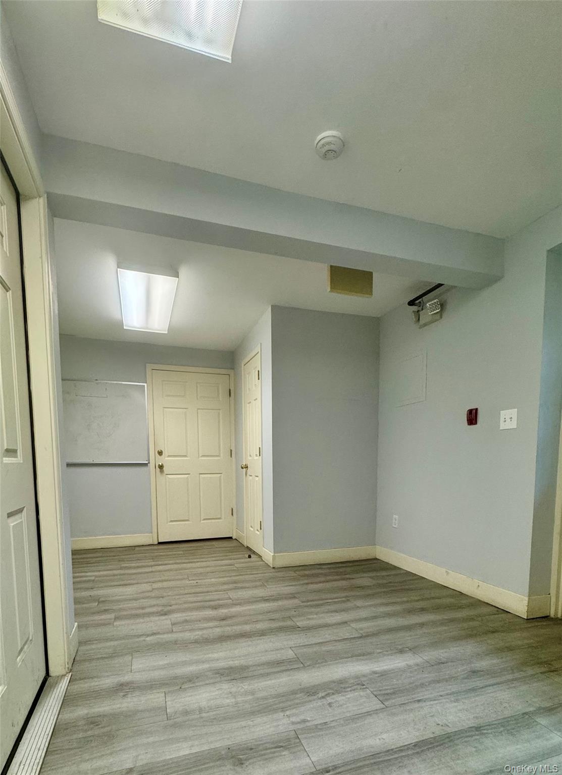 Below grade area featuring light wood finished floors and baseboards