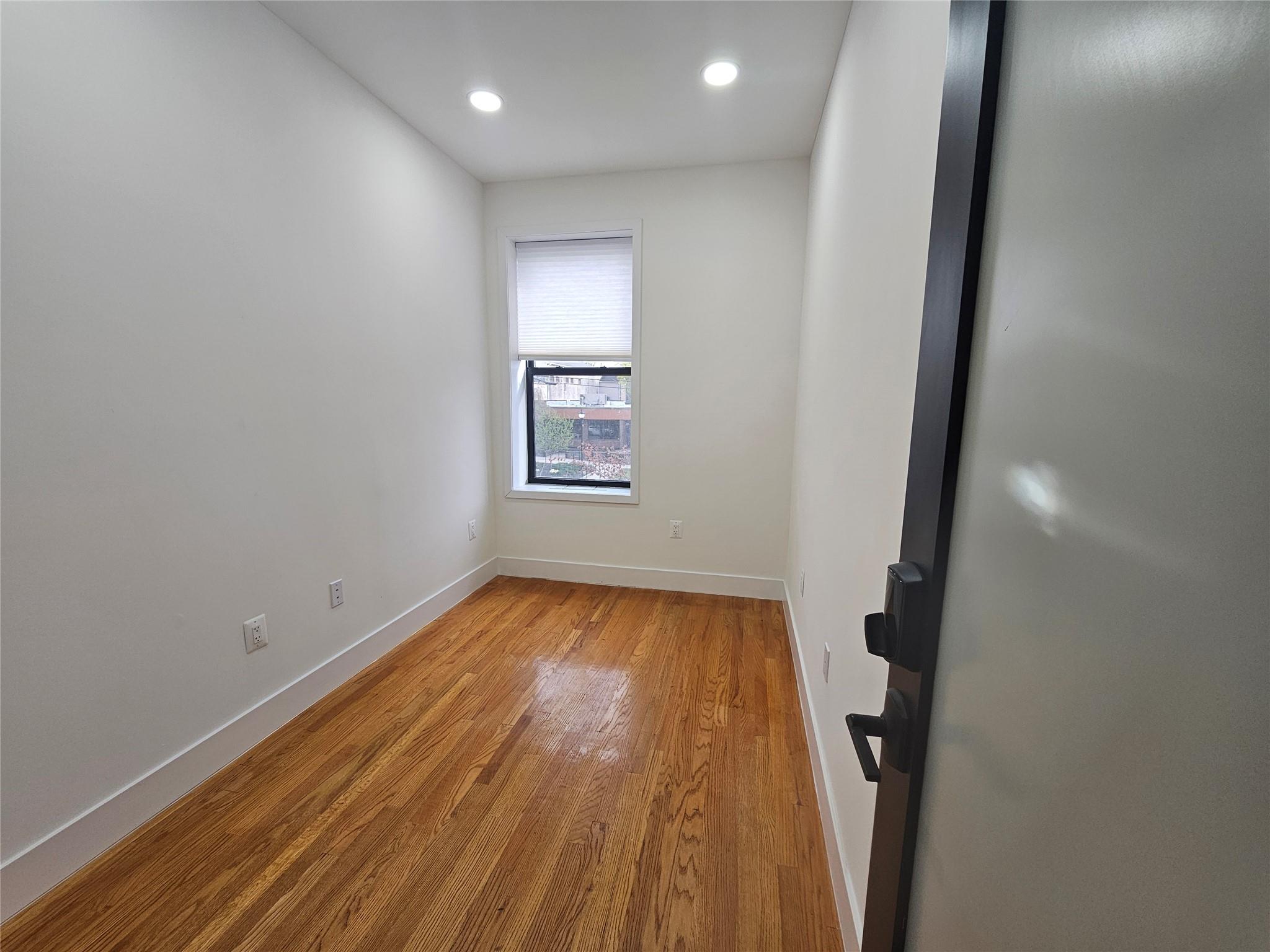 Unfurnished room with baseboards, wood finished floors, and recessed lighting
