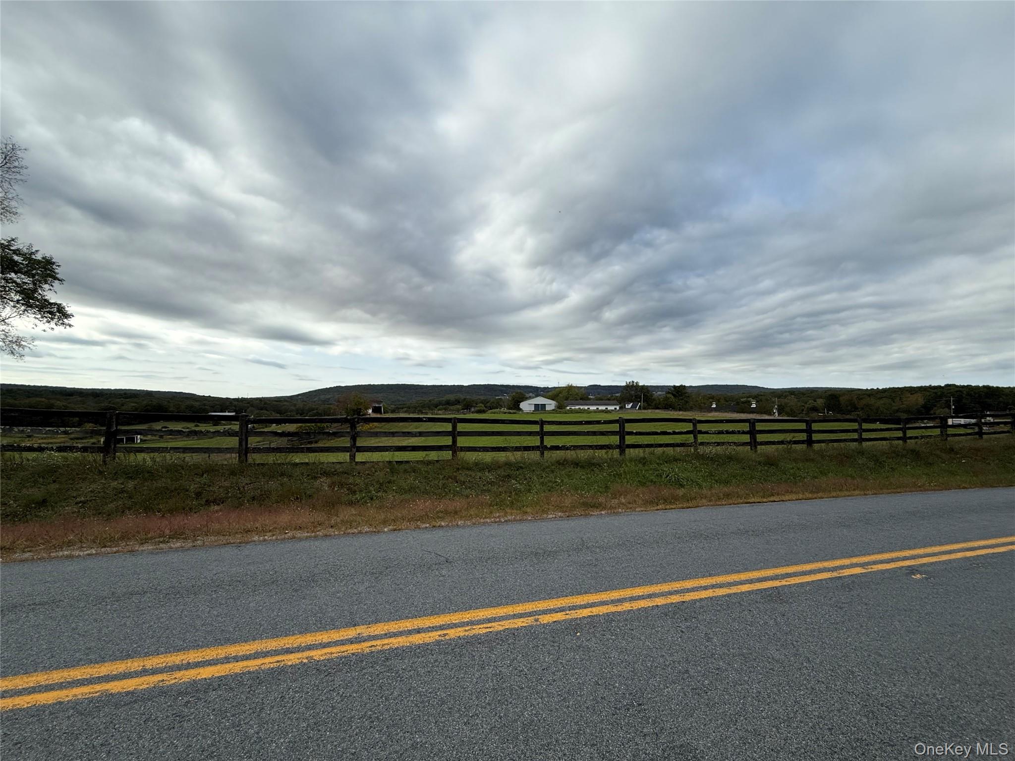 View of asphalt road featuring a view of countryside