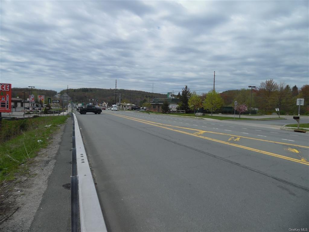 View of asphalt road featuring curbs