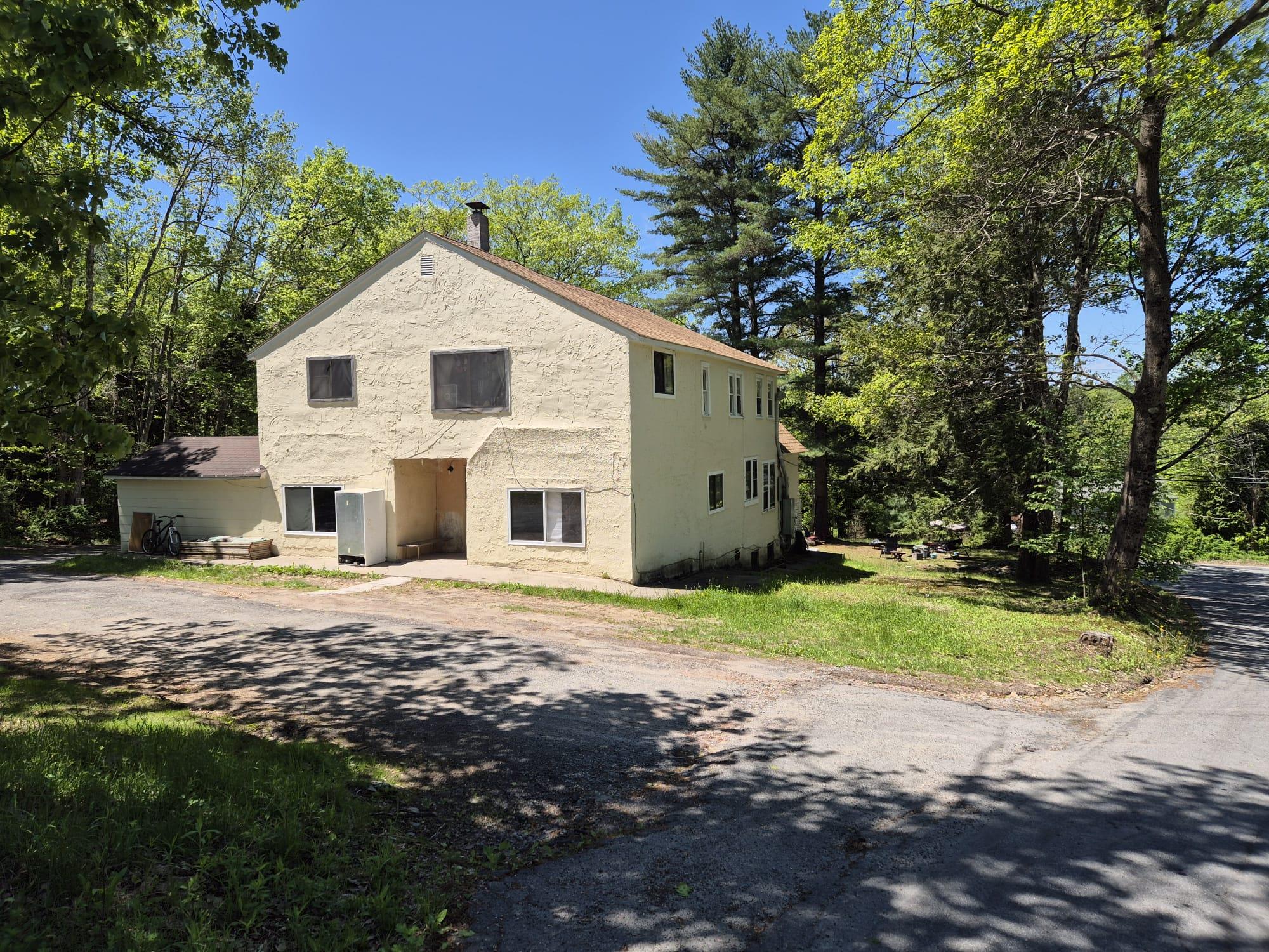 Front facade with stucco siding and a front lawn