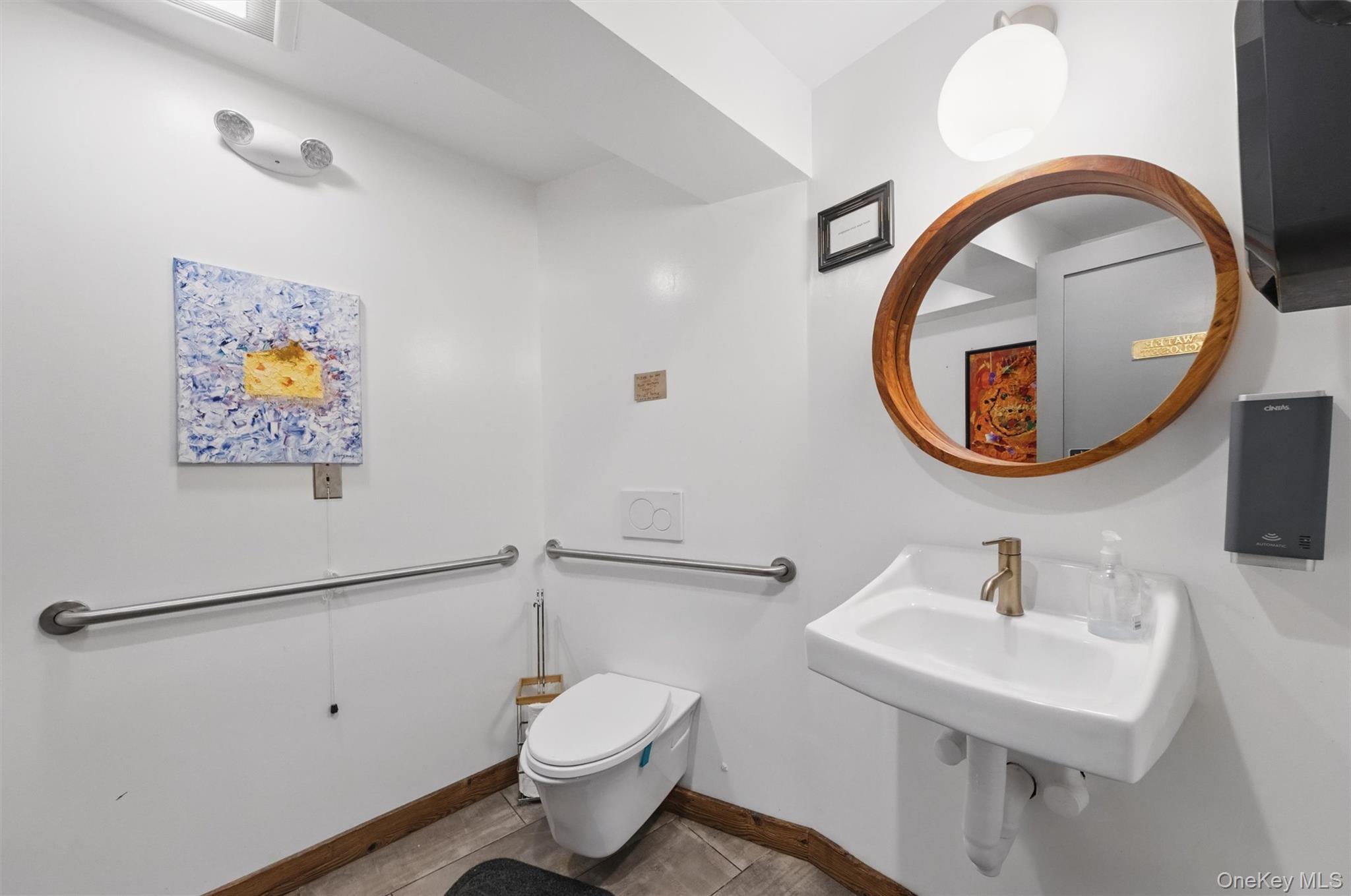 Bathroom with toilet and baseboards