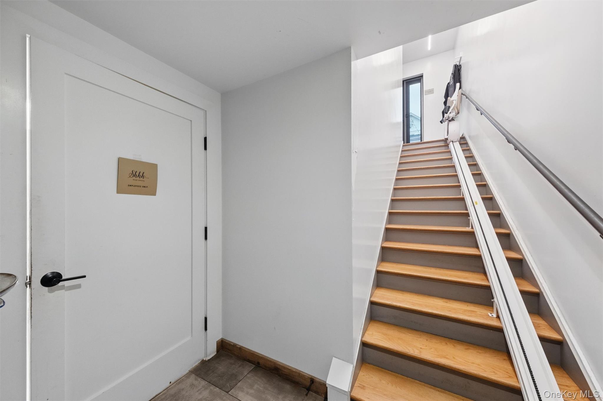 Staircase featuring baseboards