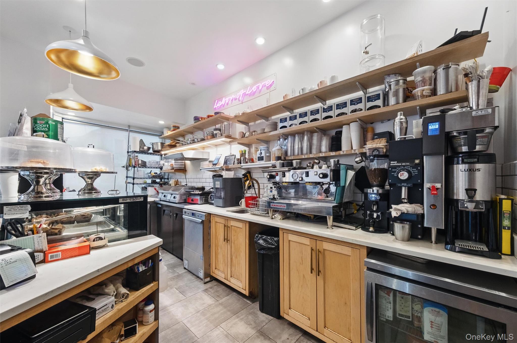 Kitchen with open shelves, light countertops, decorative backsplash, decorative light fixtures, and recessed lighting