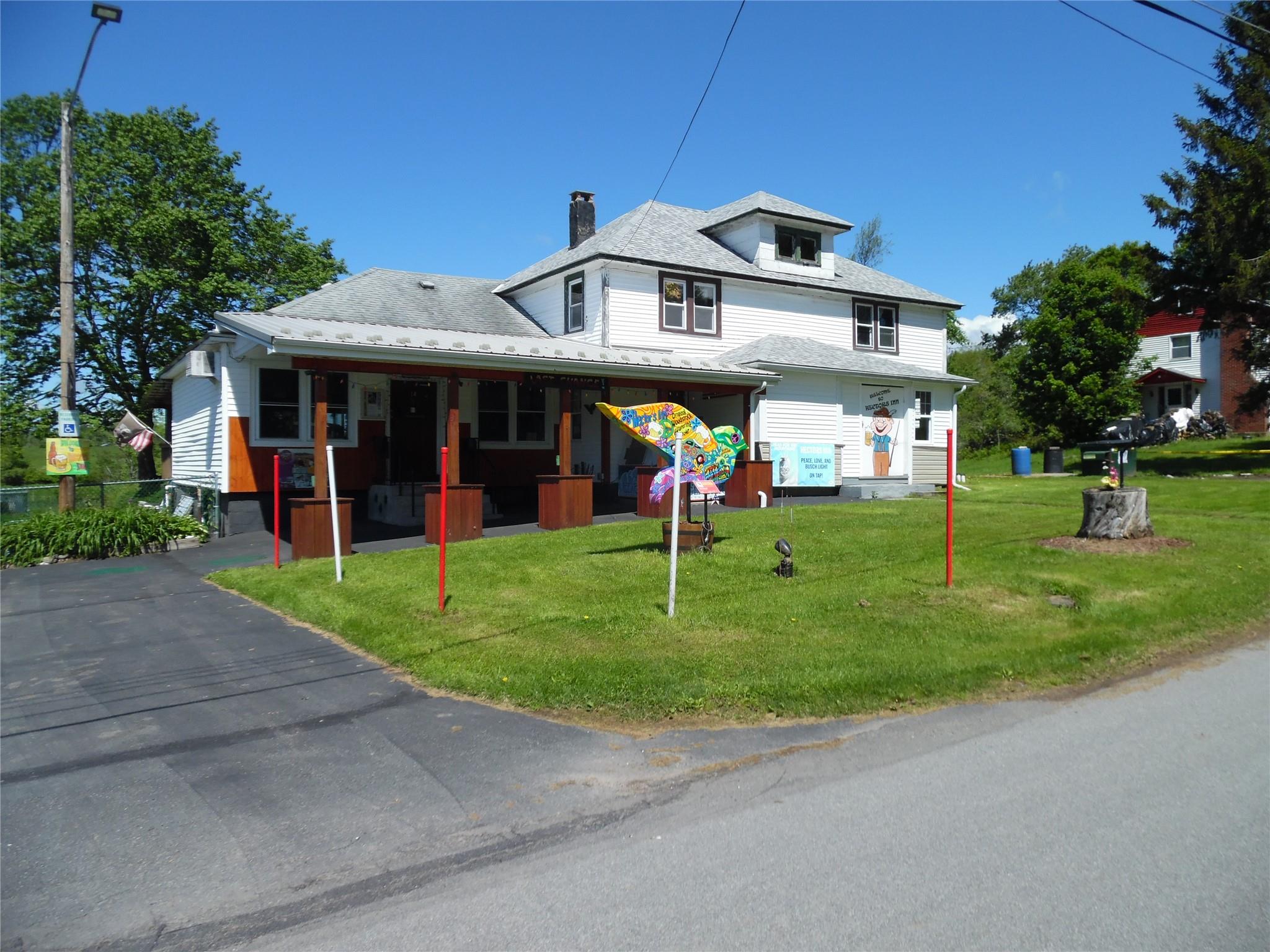 View of front of property with a chimney and a front yard