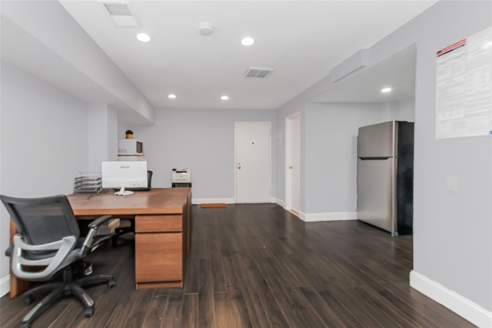 Office Area with kitchen and hardwood floors