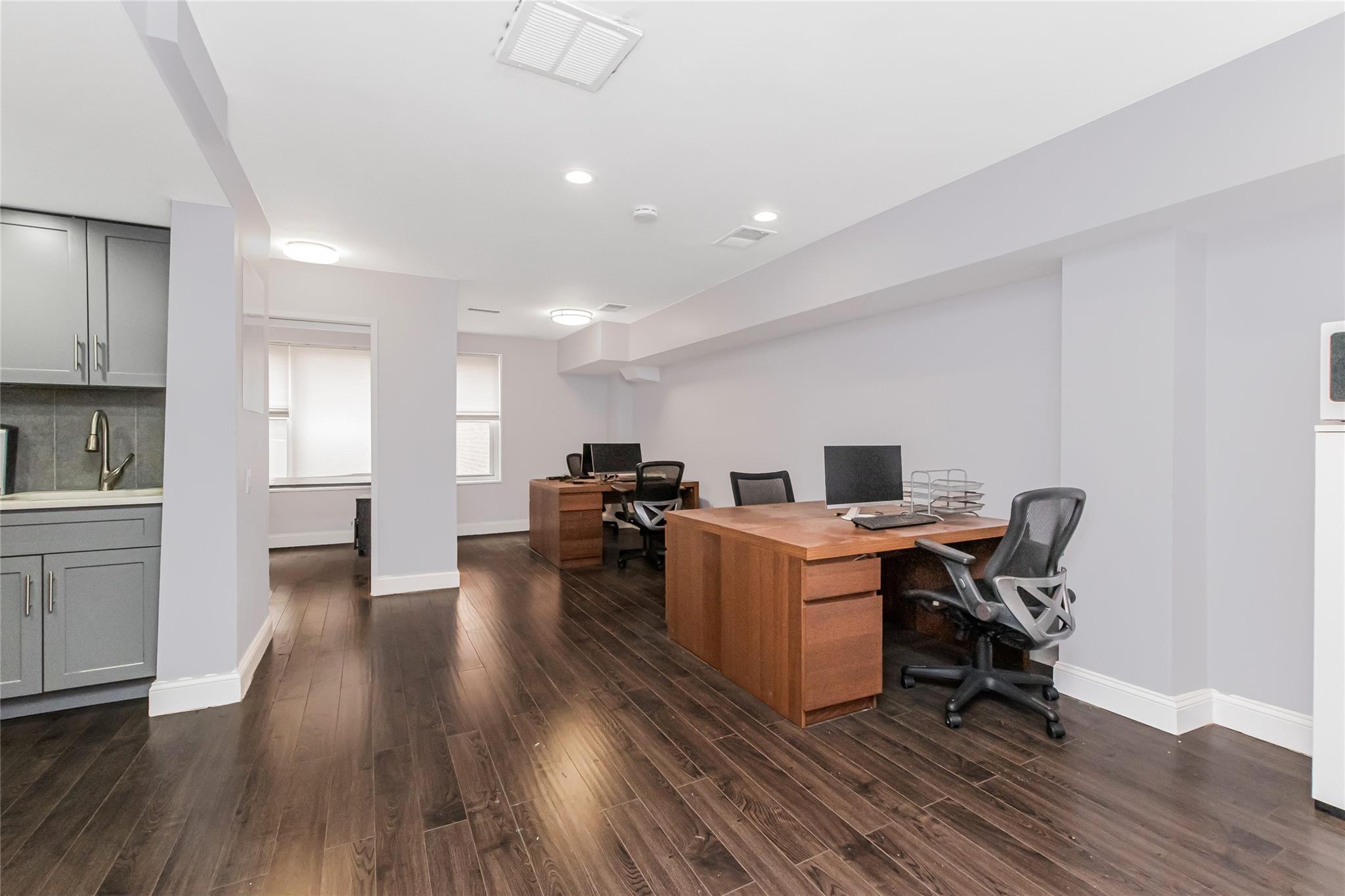 Office Area with kitchen and hardwood floors