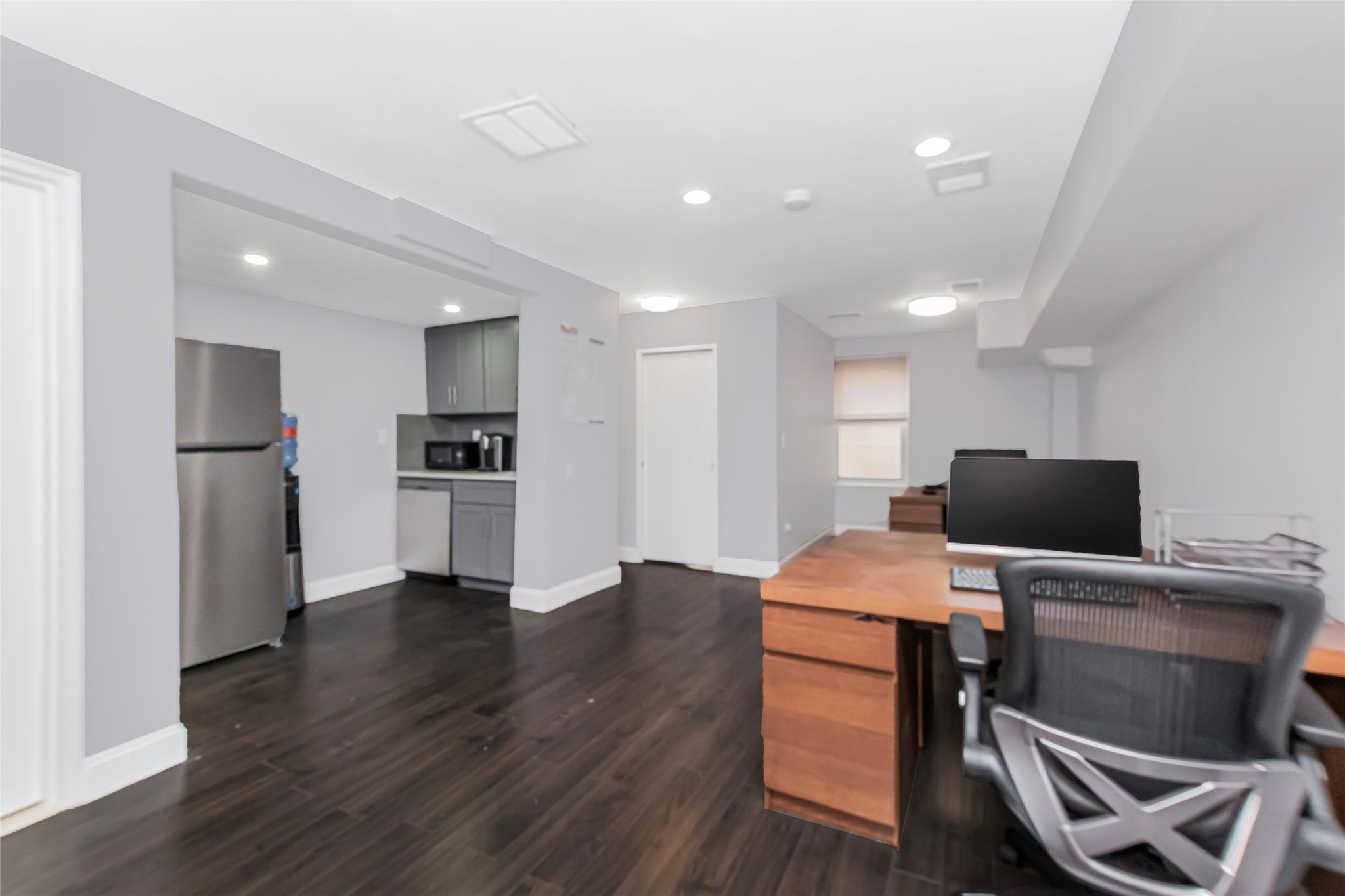 Office Area with kitchen and hardwood floors