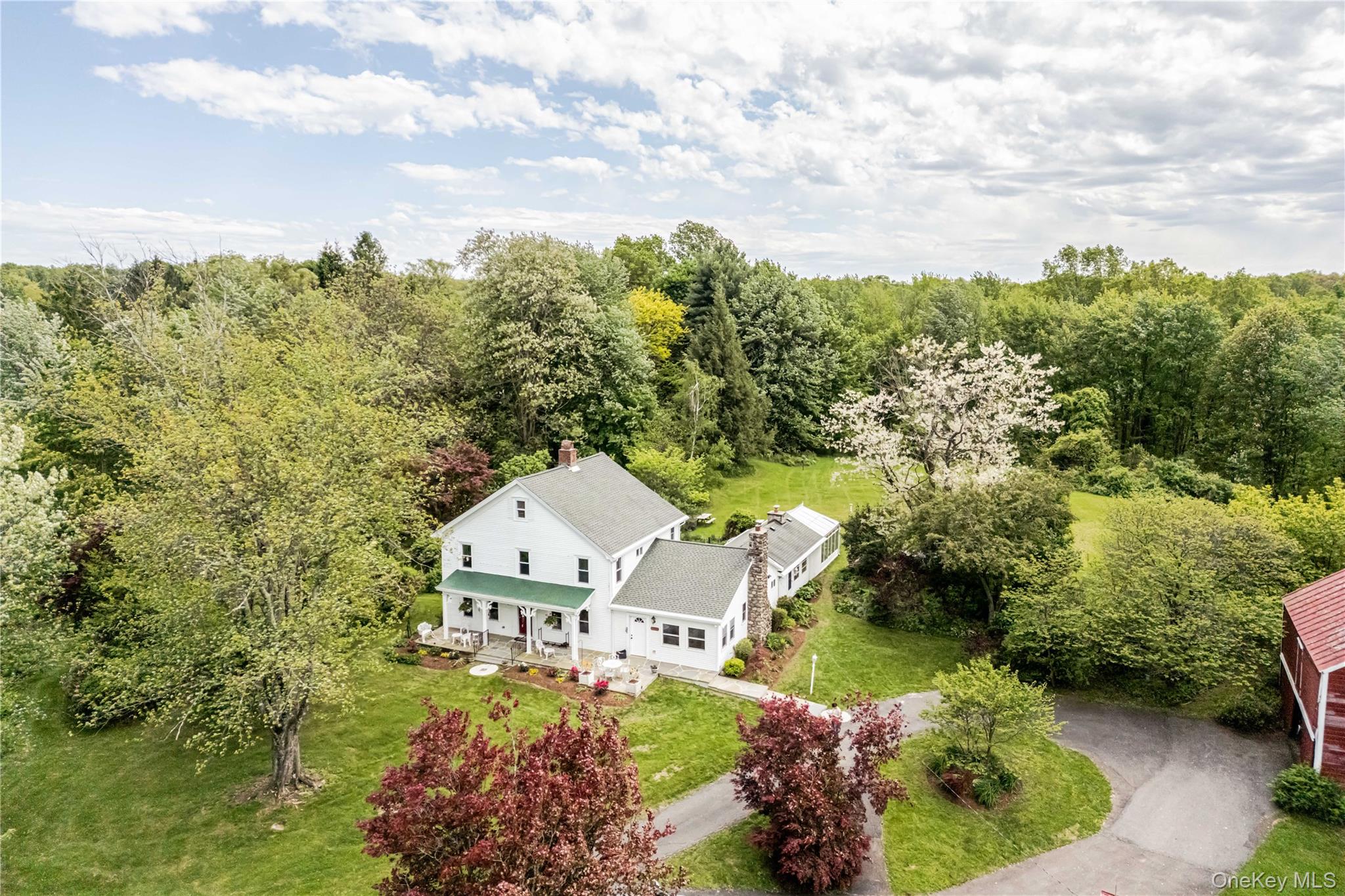 View from above of property with a heavily wooded area