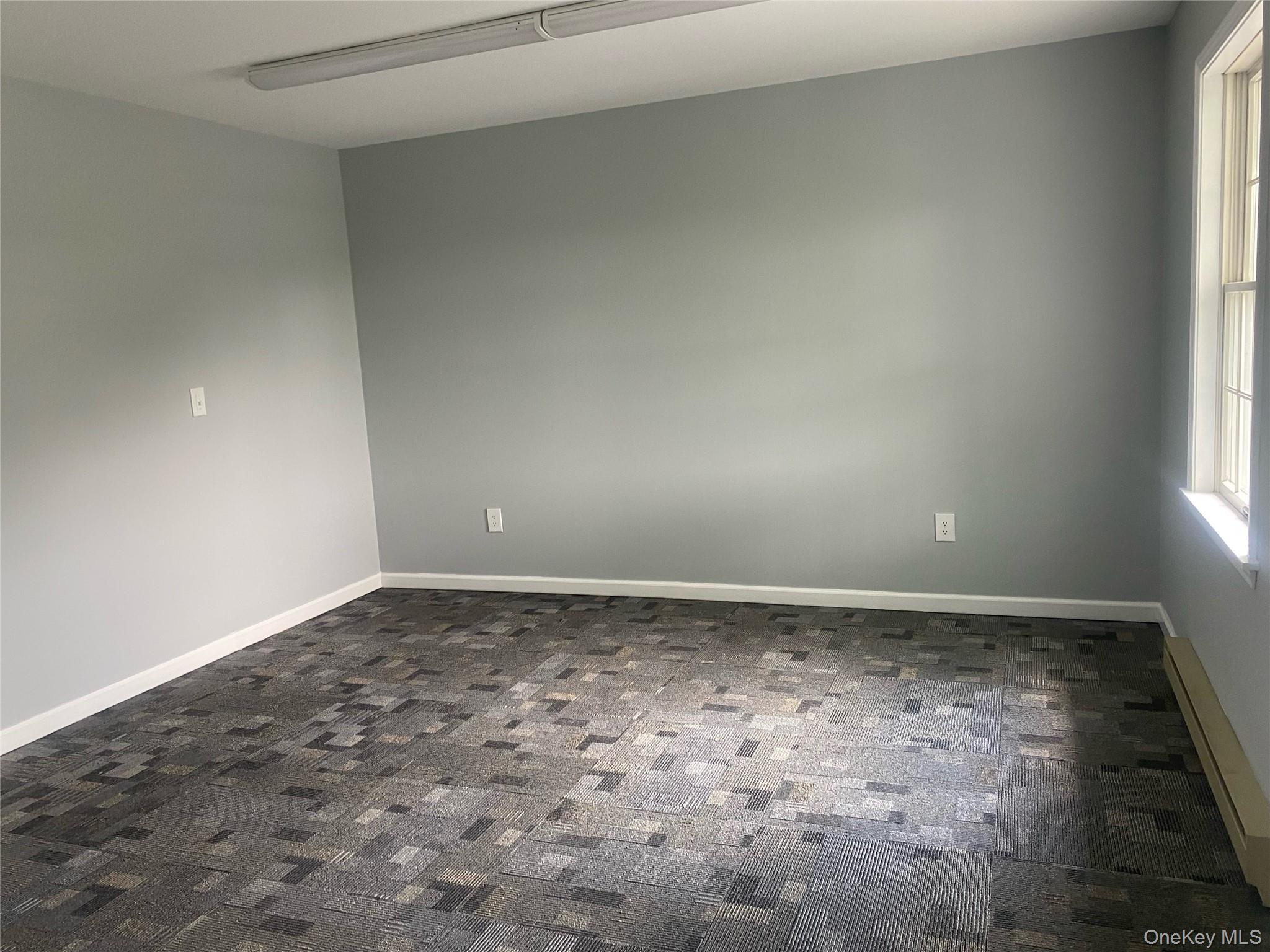 Unfurnished room featuring baseboards