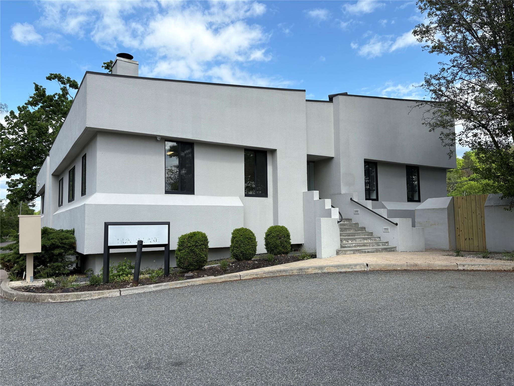 View of front of property featuring stucco siding and a chimney