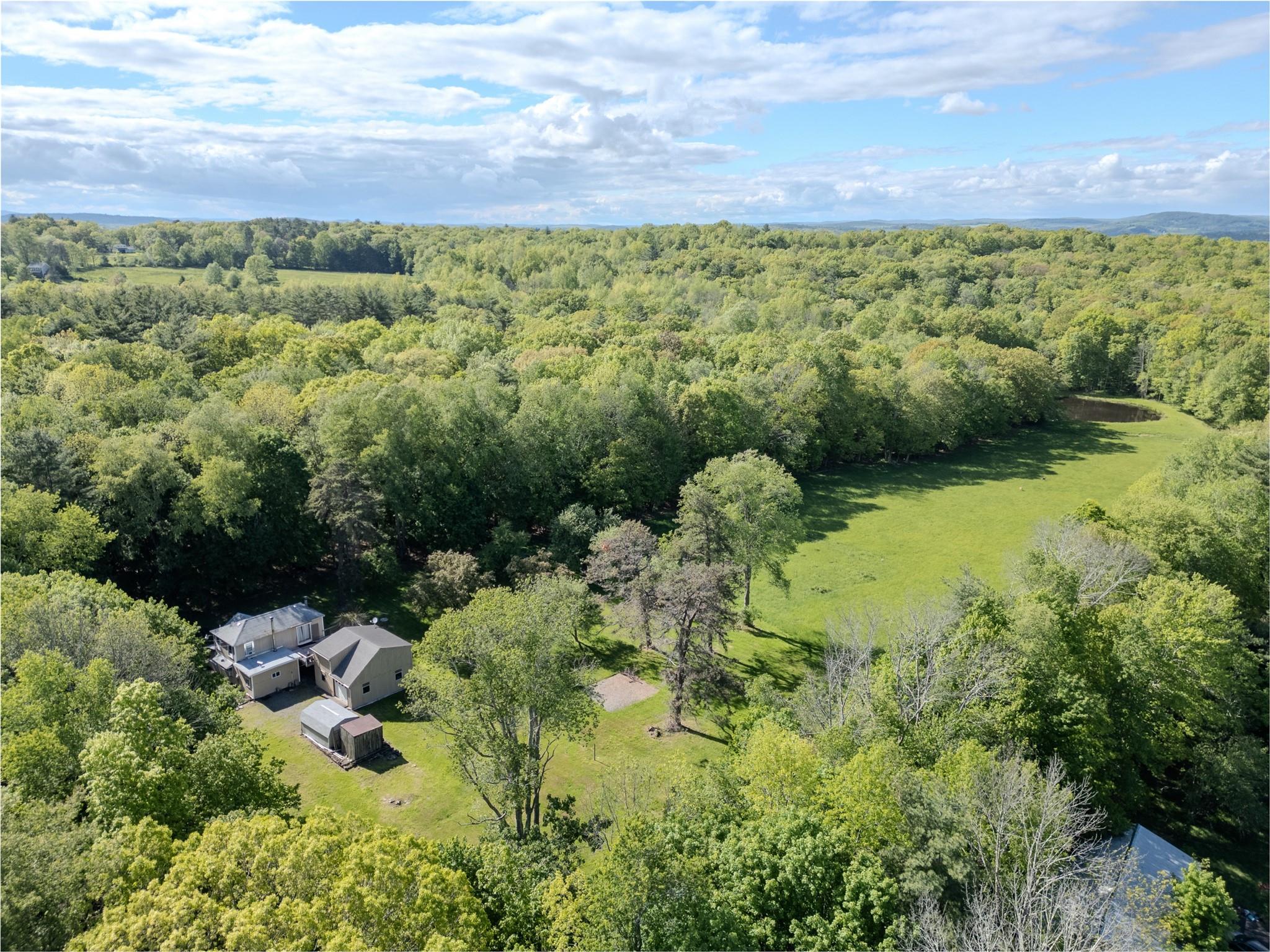 View from above of property featuring a heavily wooded area