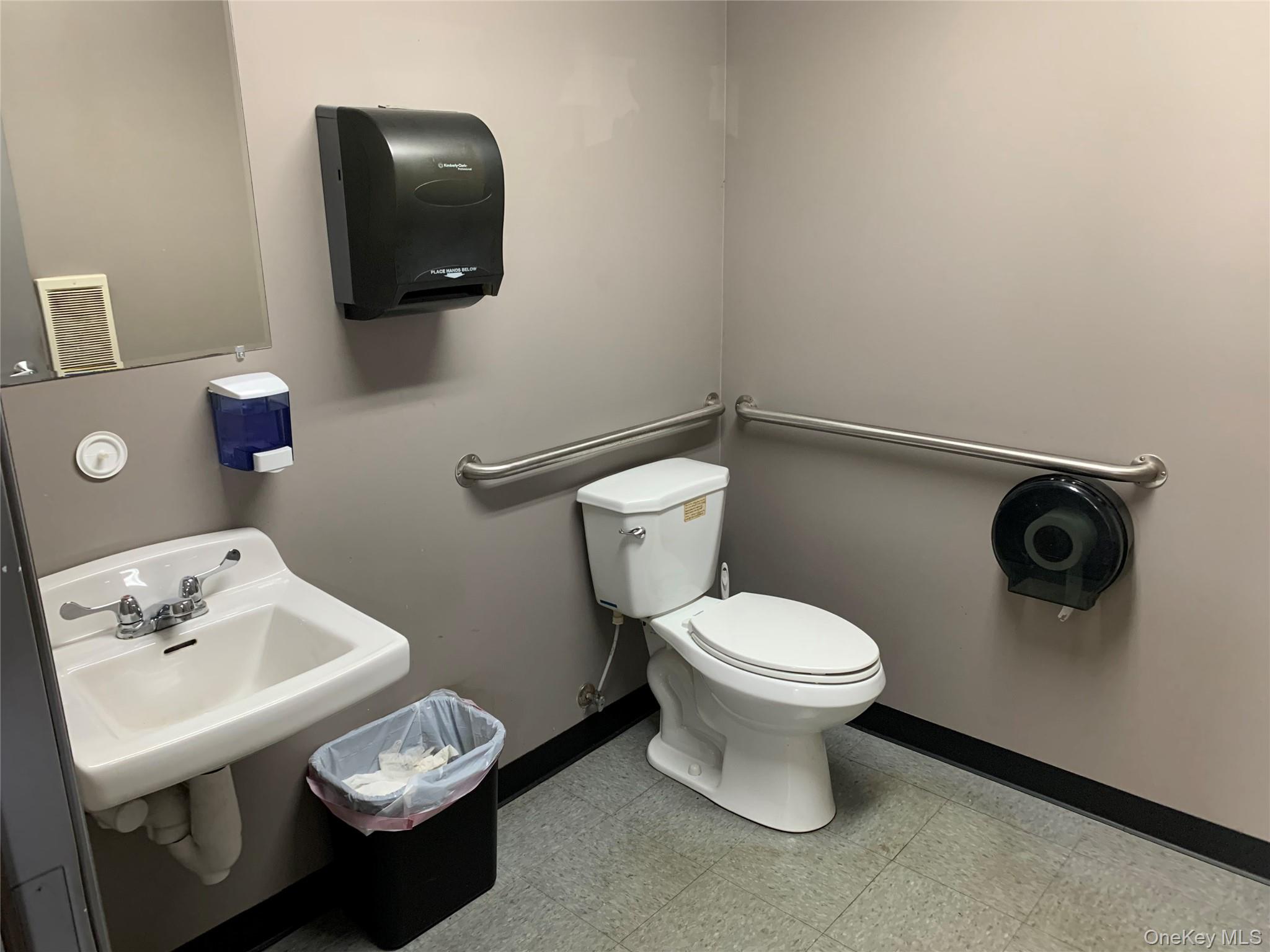 Half bath featuring toilet, baseboards, and tile patterned floors