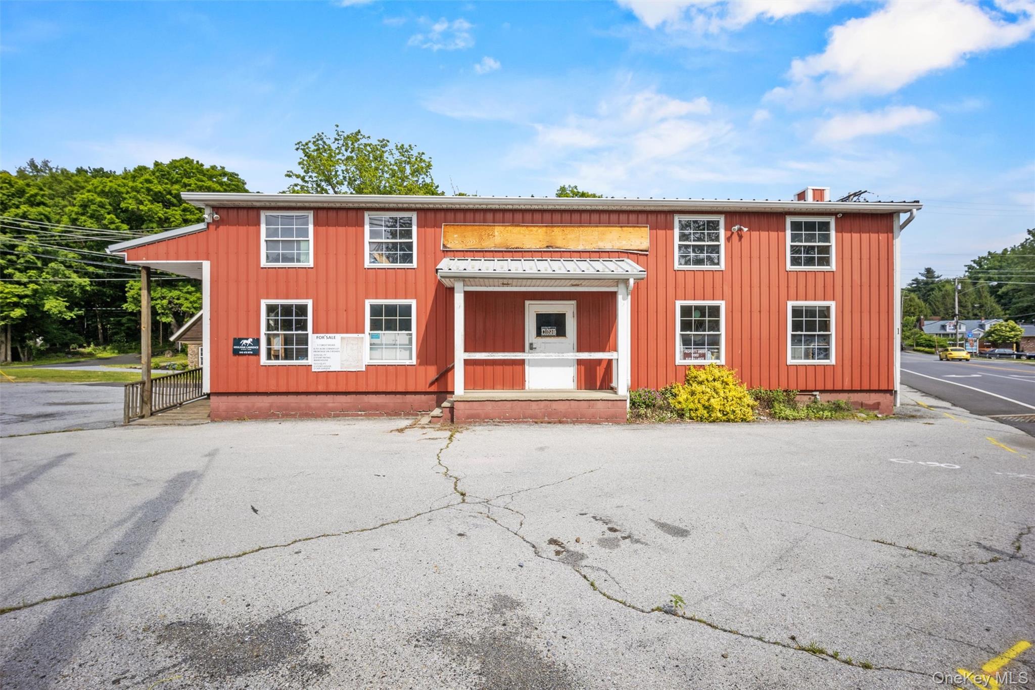 View of front of house with metal roof and board and batten siding