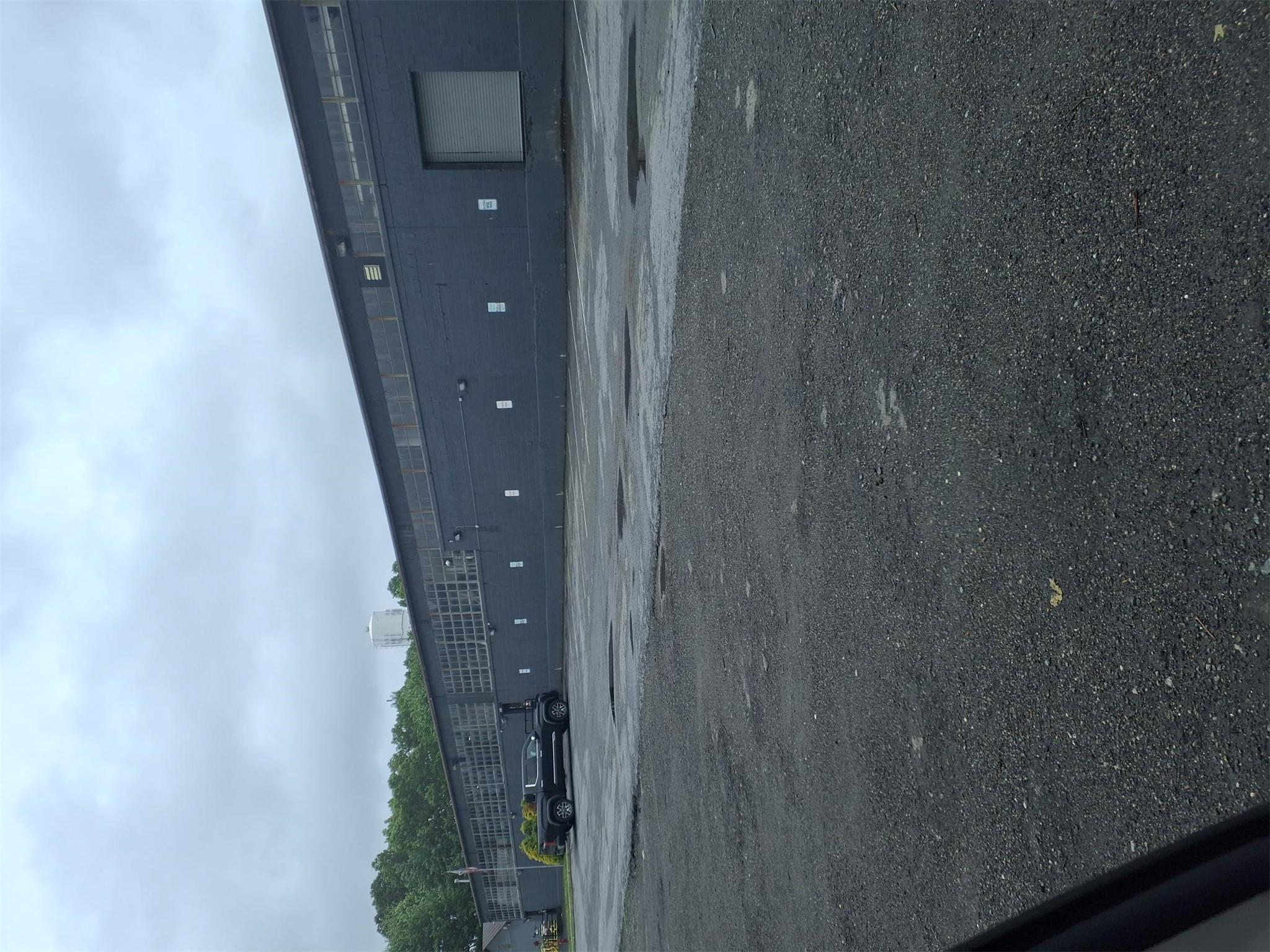 View of building exterior with uncovered parking