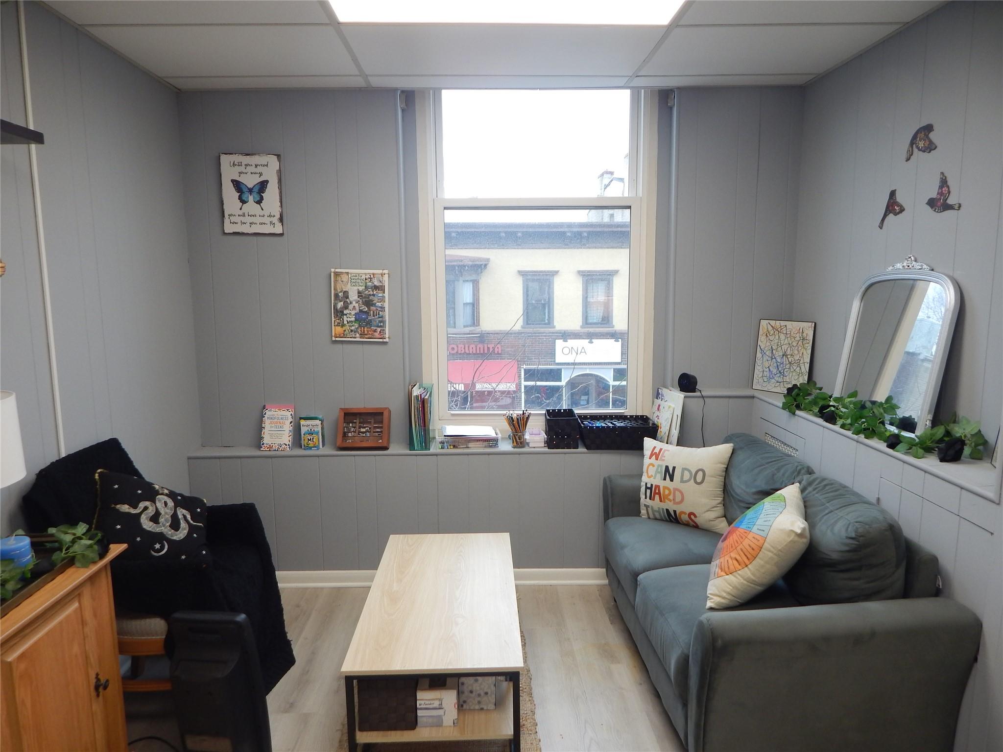 Office with a paneled ceiling and light hardwood / wood-style floors