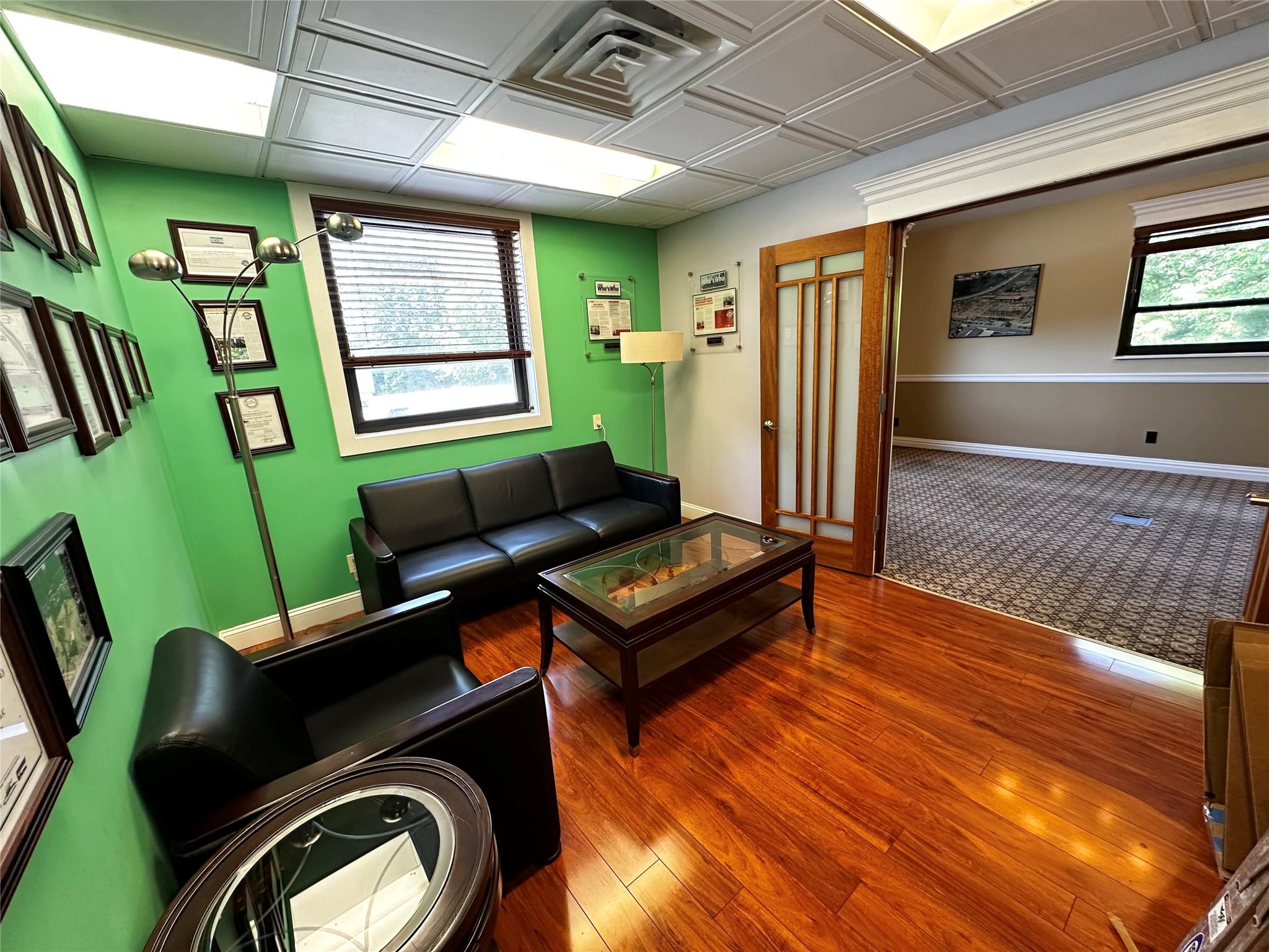 Living area with wood finished floors and baseboards