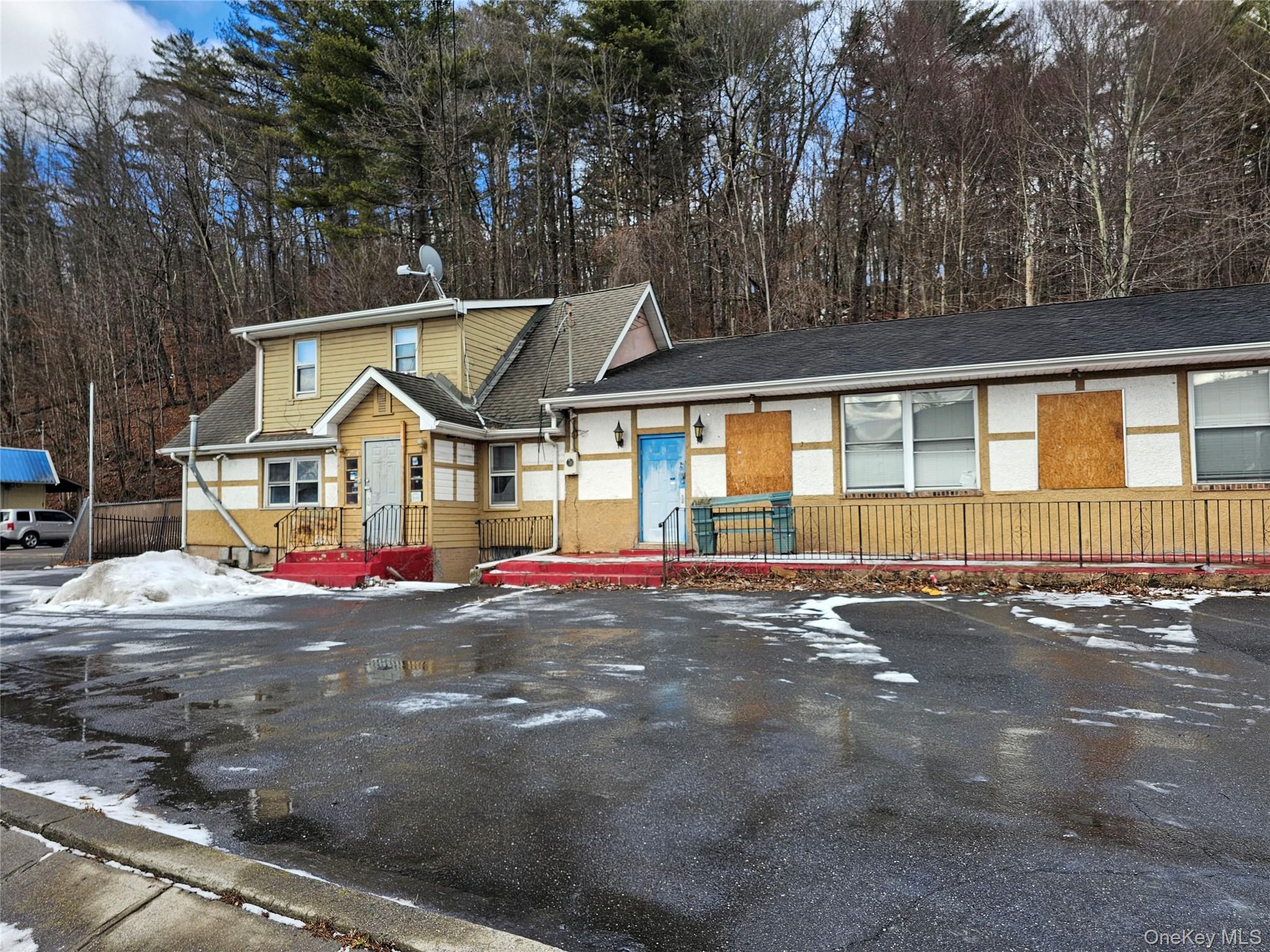 Tri-level home featuring stucco siding and uncovered parking
