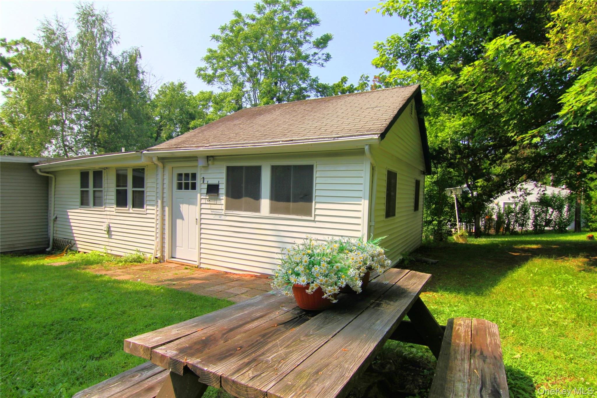 Wooden terrace featuring a yard