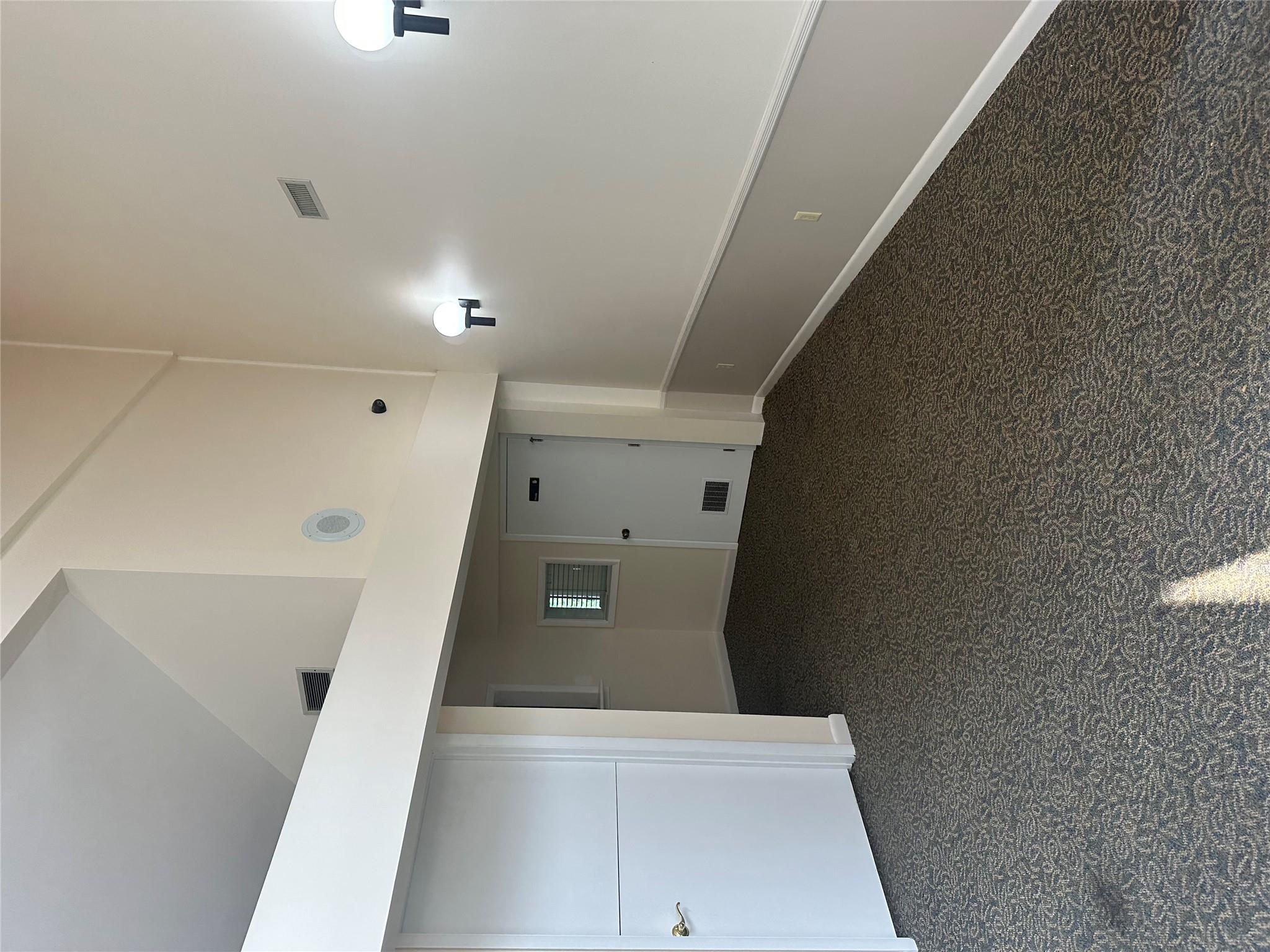 Unfurnished room with high vaulted ceiling and carpet